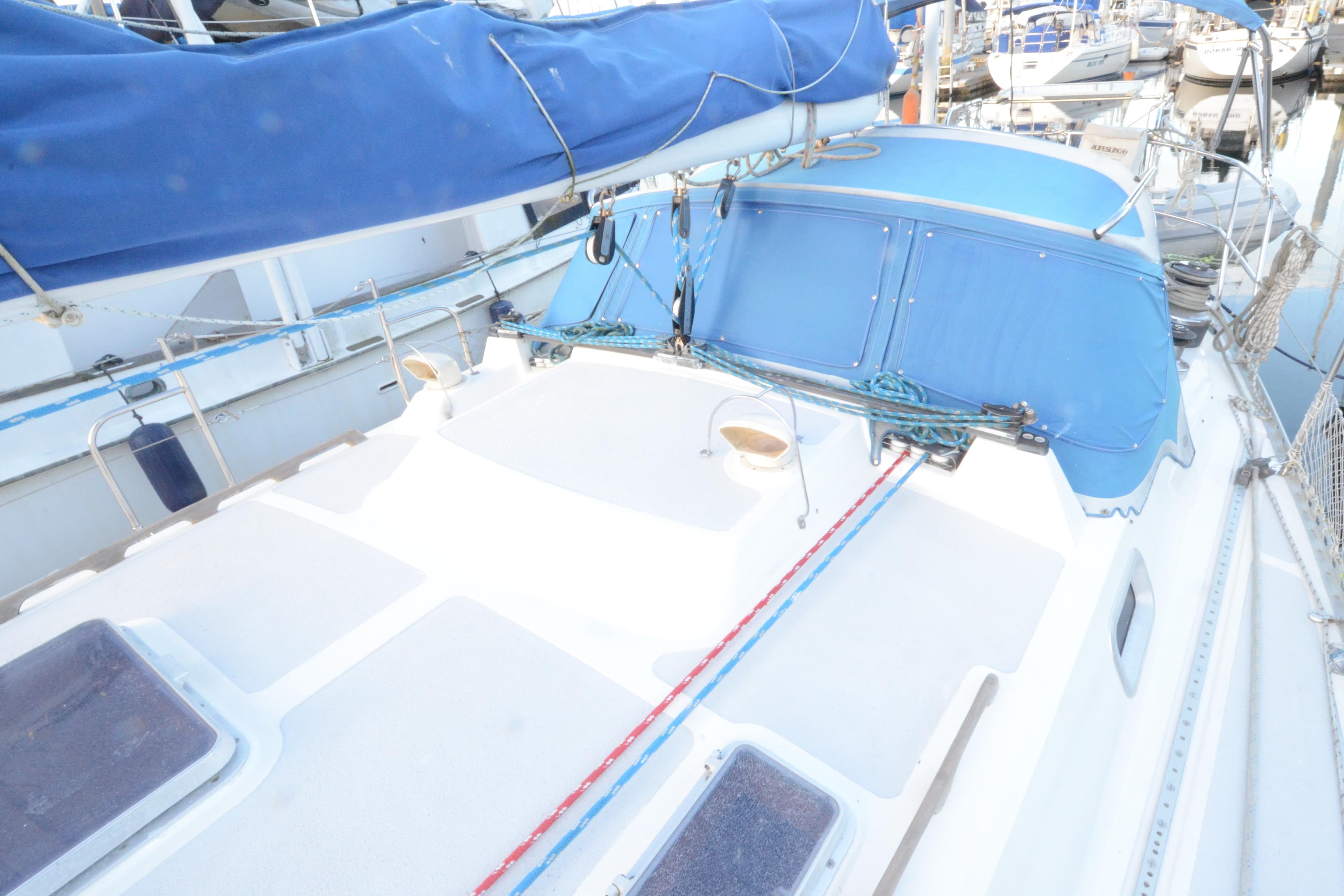 Sailboat deck of 1983 Nordic 44 with blue covers and rigging.