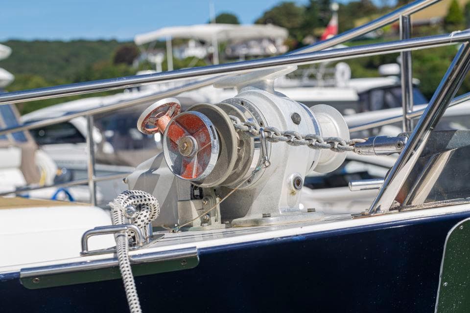 Anchor winch on a 2002 Hardy Commodore 42 boat, docked in a marina.