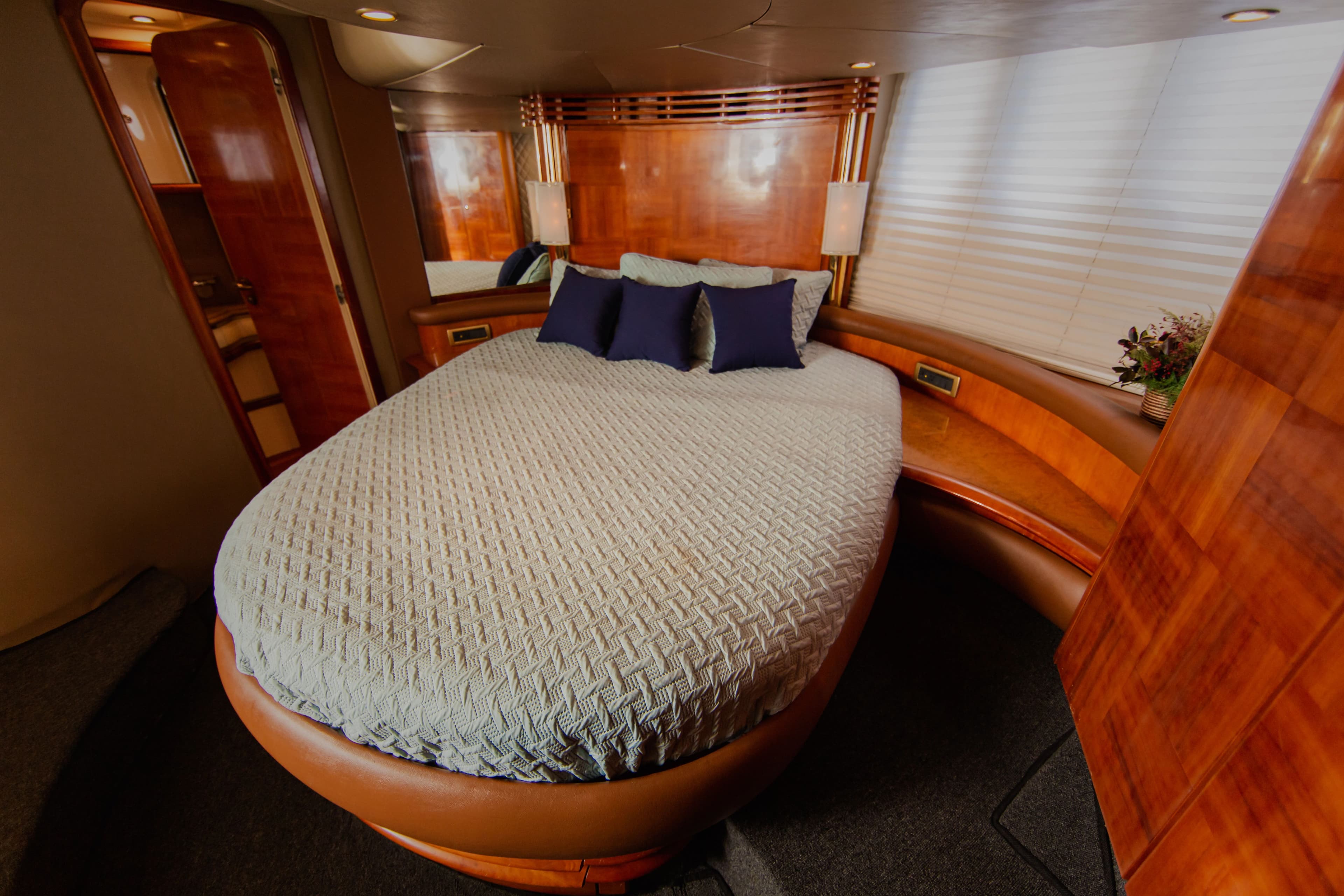 Luxurious bedroom on a 2004 Azimut 55E yacht.