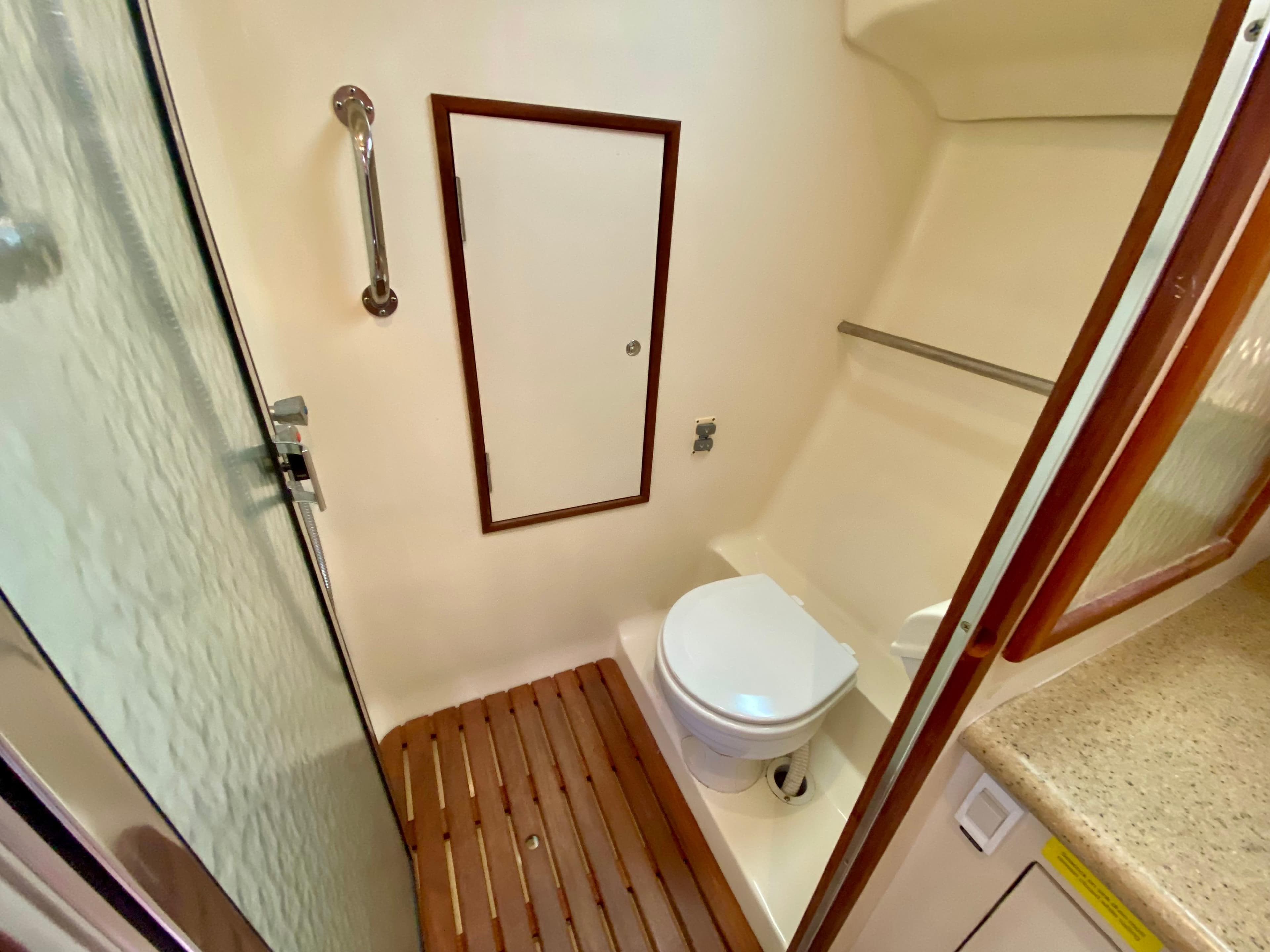 2008 Hunter 36-2 yacht bathroom with shower, toilet, and wooden floor.