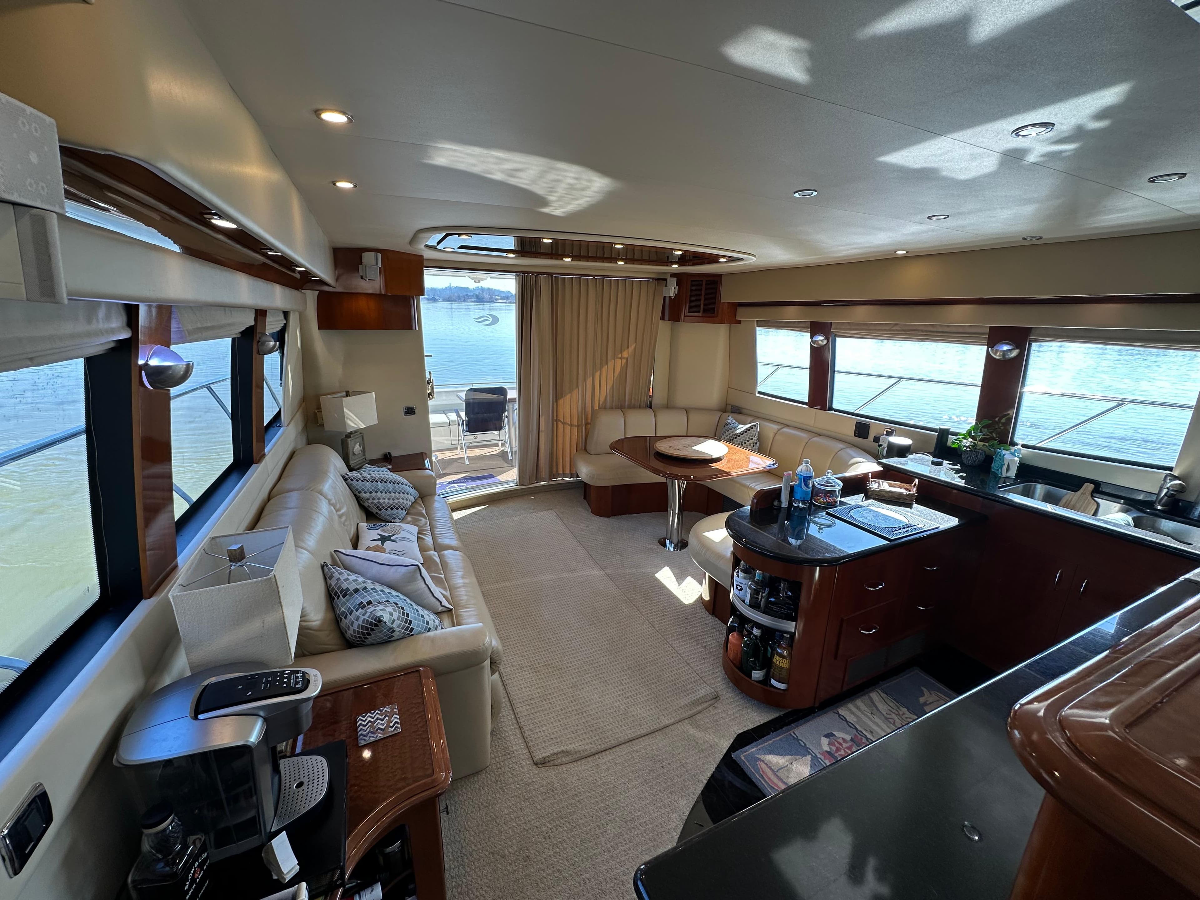 Luxurious interior of a 2005 Carver 56 Voyager yacht with elegant furnishings and panoramic windows.