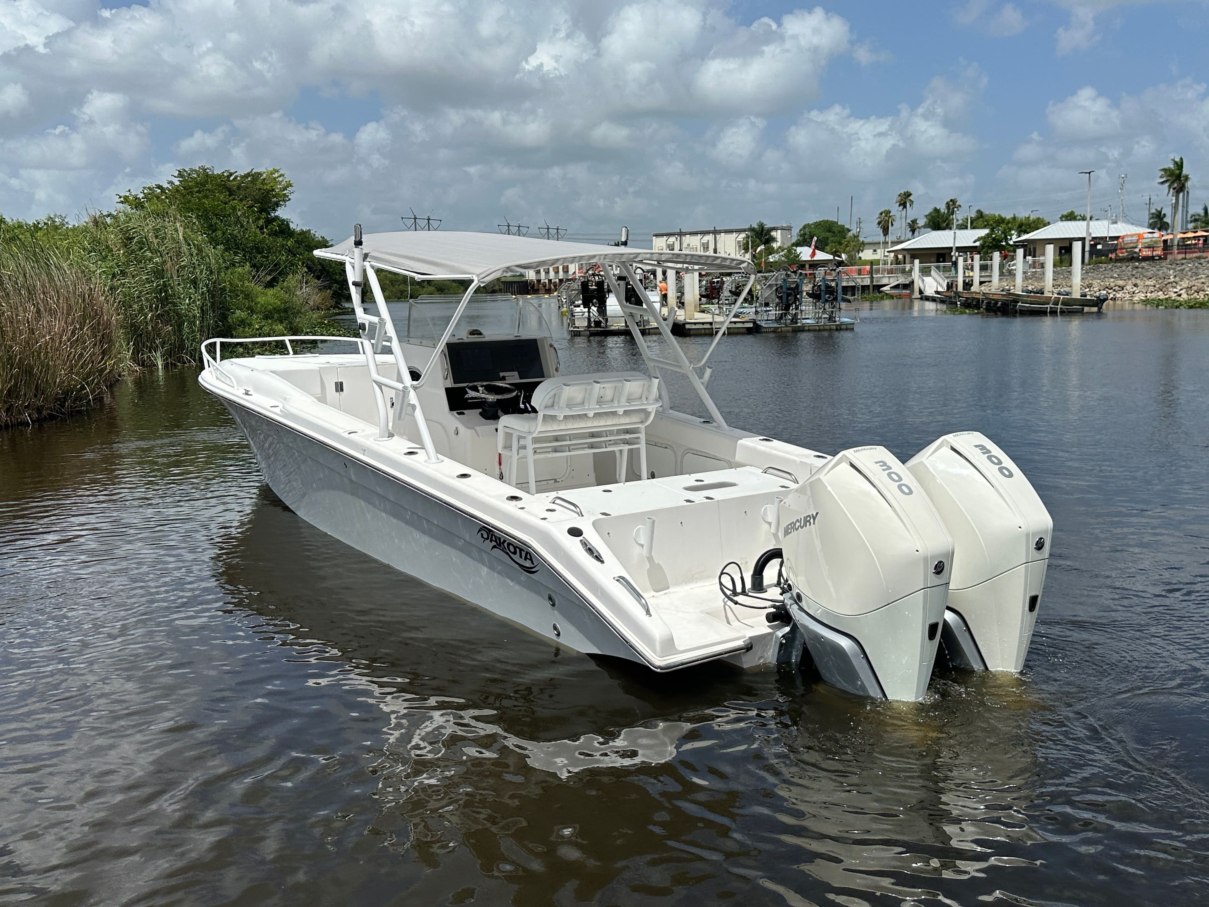 2006 Dakota 36 Cuddy boat with twin engines on calm water.