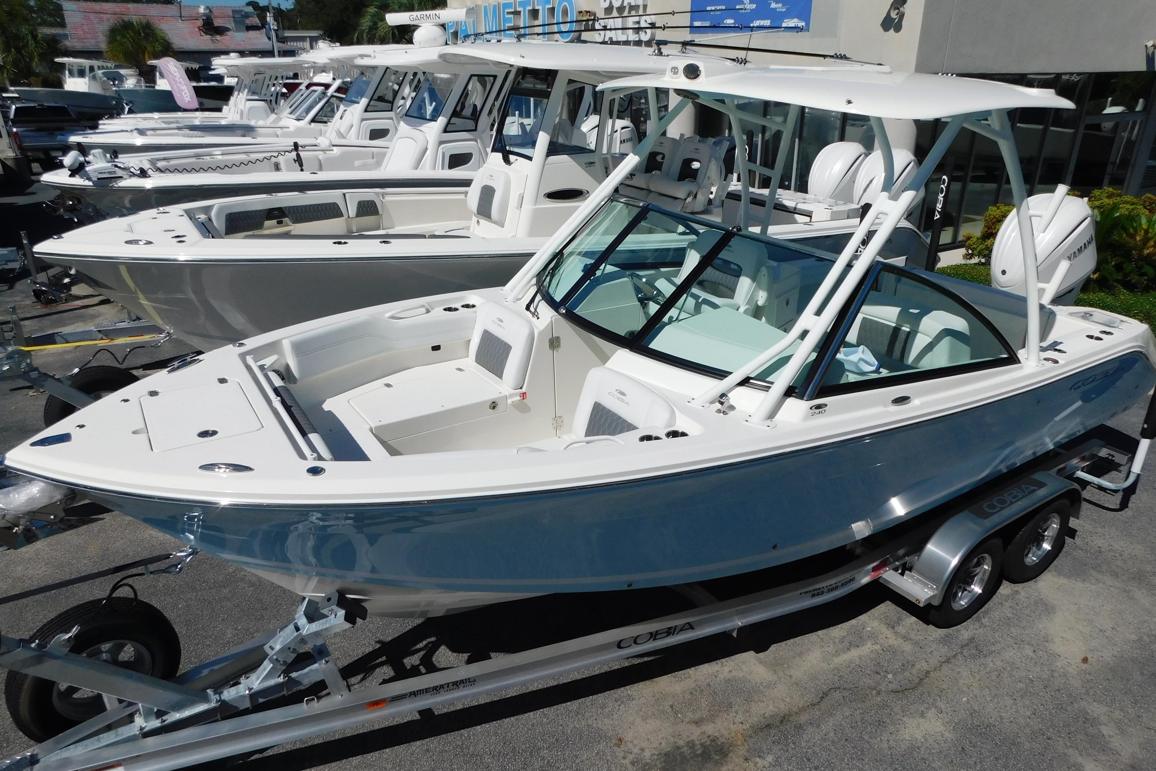 2026 Cobia 240 Dual Console boat on trailer, displayed at dealership.