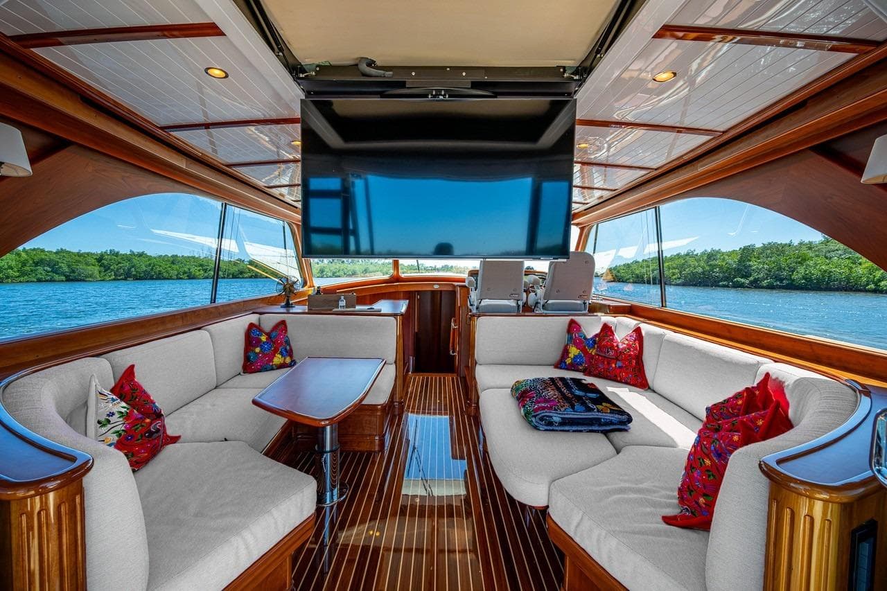 Luxurious 2021 Hinckley Talaria yacht interior with elegant seating and vibrant cushions.