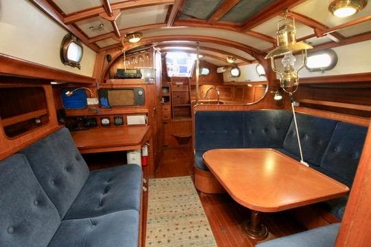 Interior of 1981 Ta-Shing Panda 40 sailboat with wooden furnishings and blue seating.