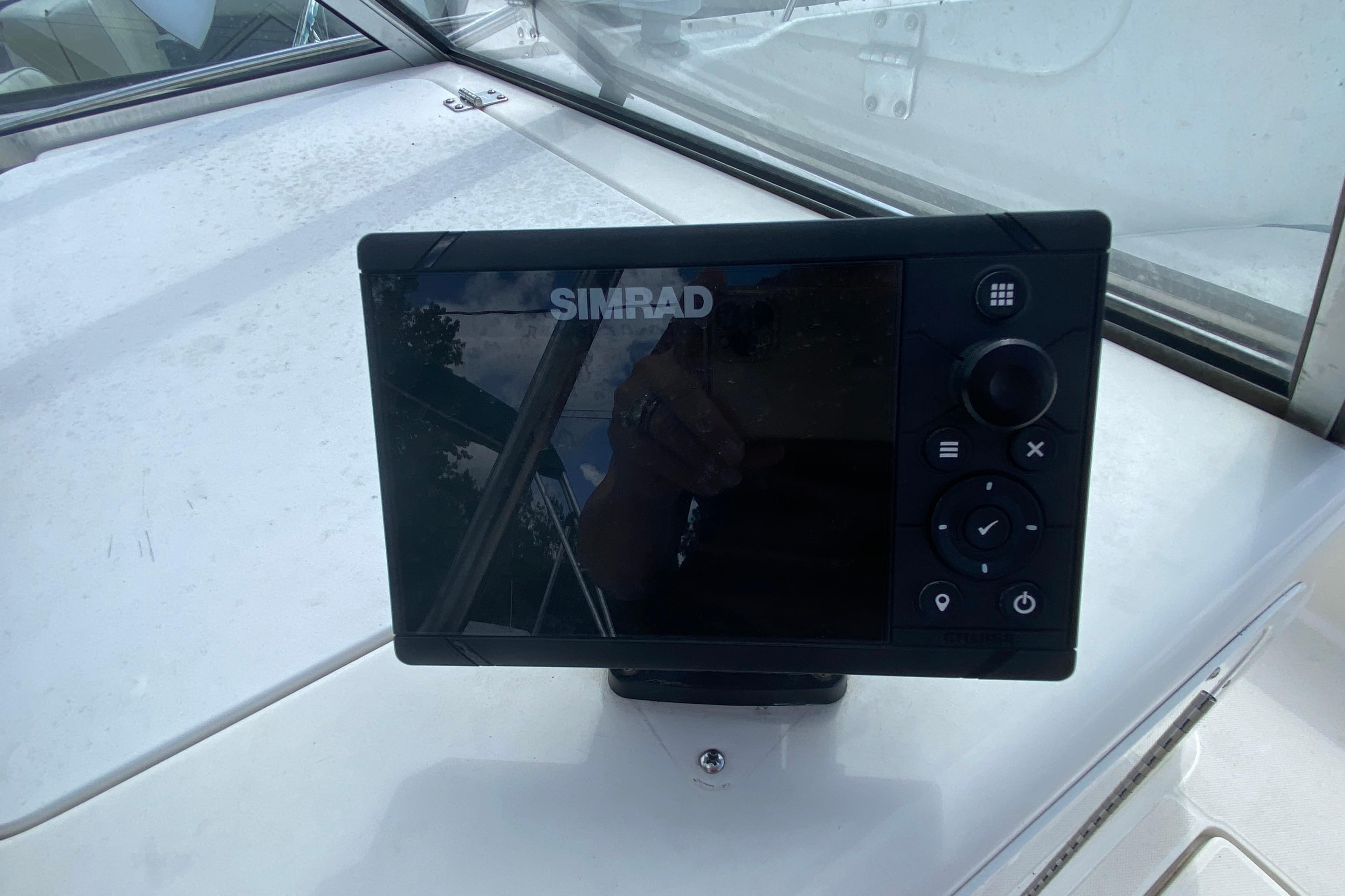 Simrad marine display on 2001 Aquasport 215 Osprey Sport boat dashboard.