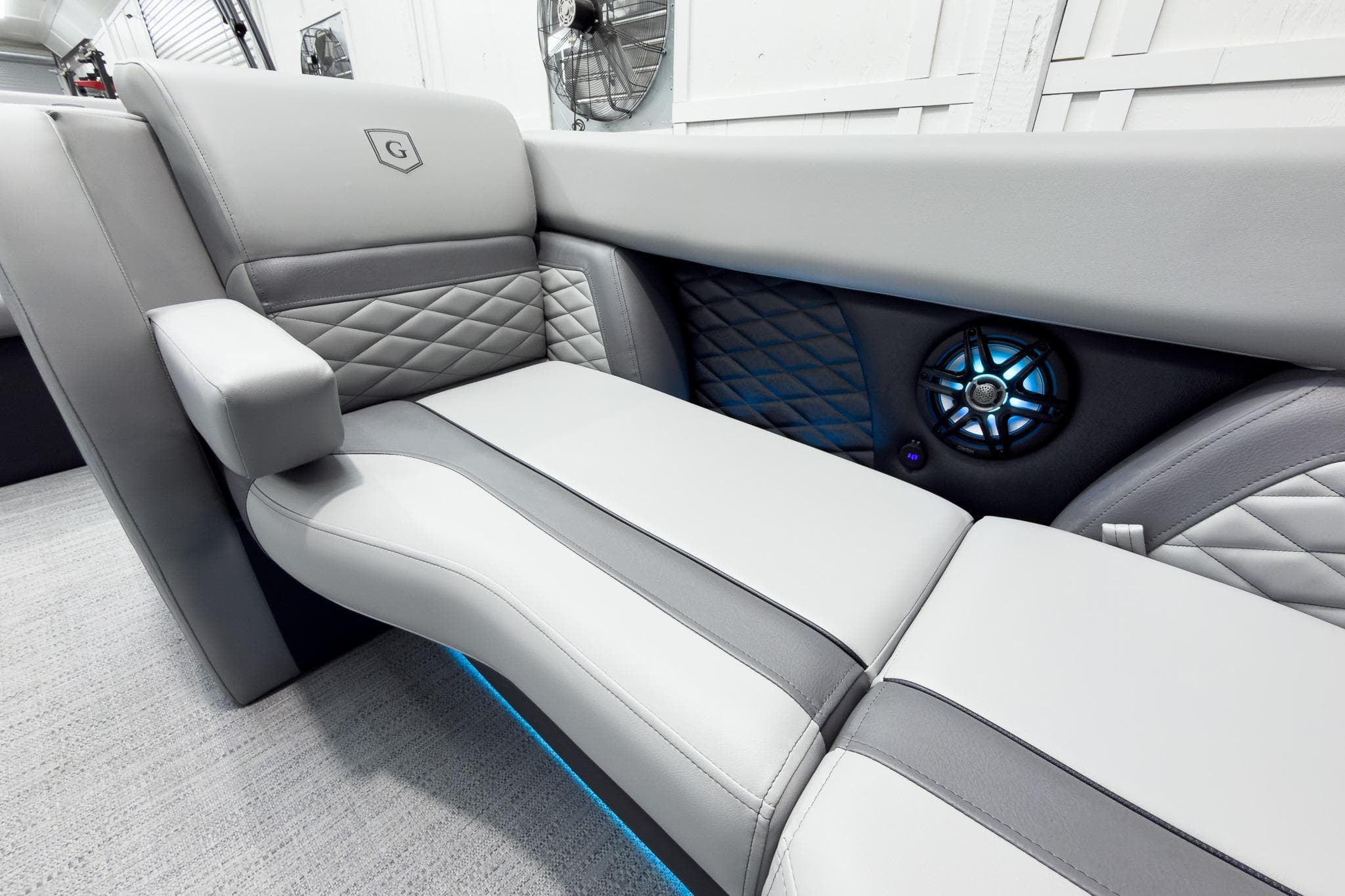 Luxurious seating in 2026 Godfrey Monaco 25' Tritoon with stylish design and integrated speaker.