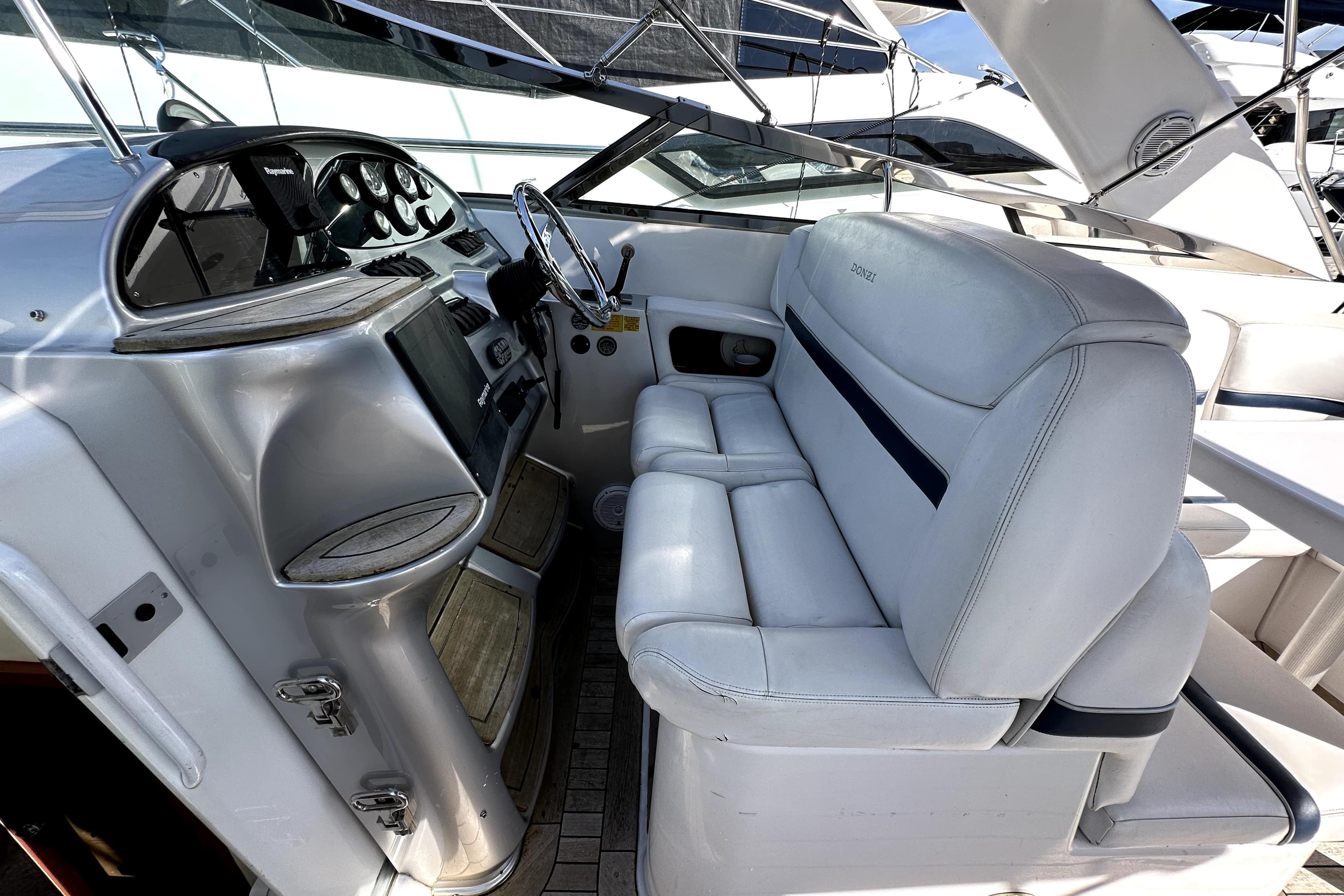 2003 Donzi 39 ZSC boat cockpit with white leather seating and modern dashboard.