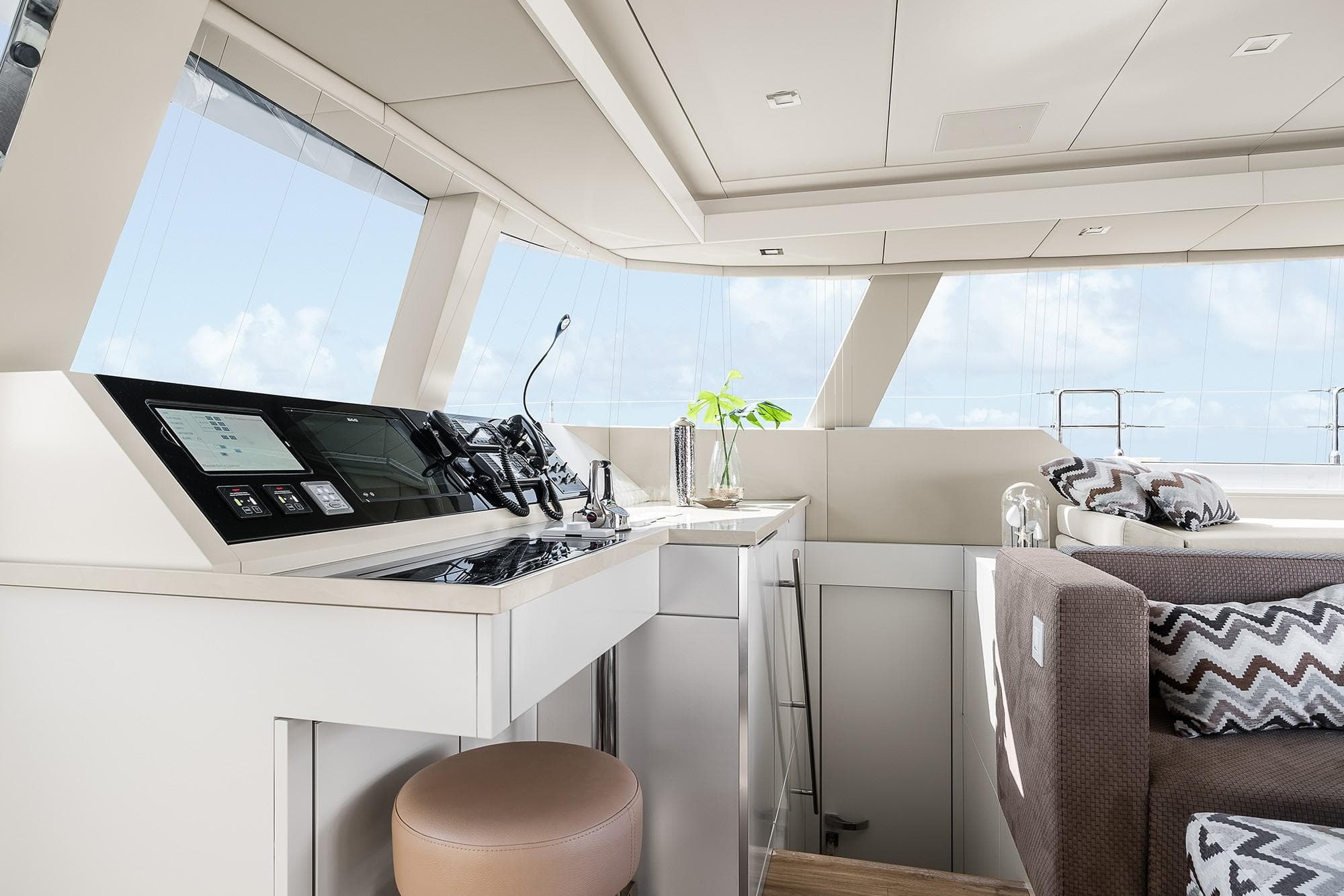 Luxurious interior of 2026 Sunreef 50 yacht with modern helm and seating area.