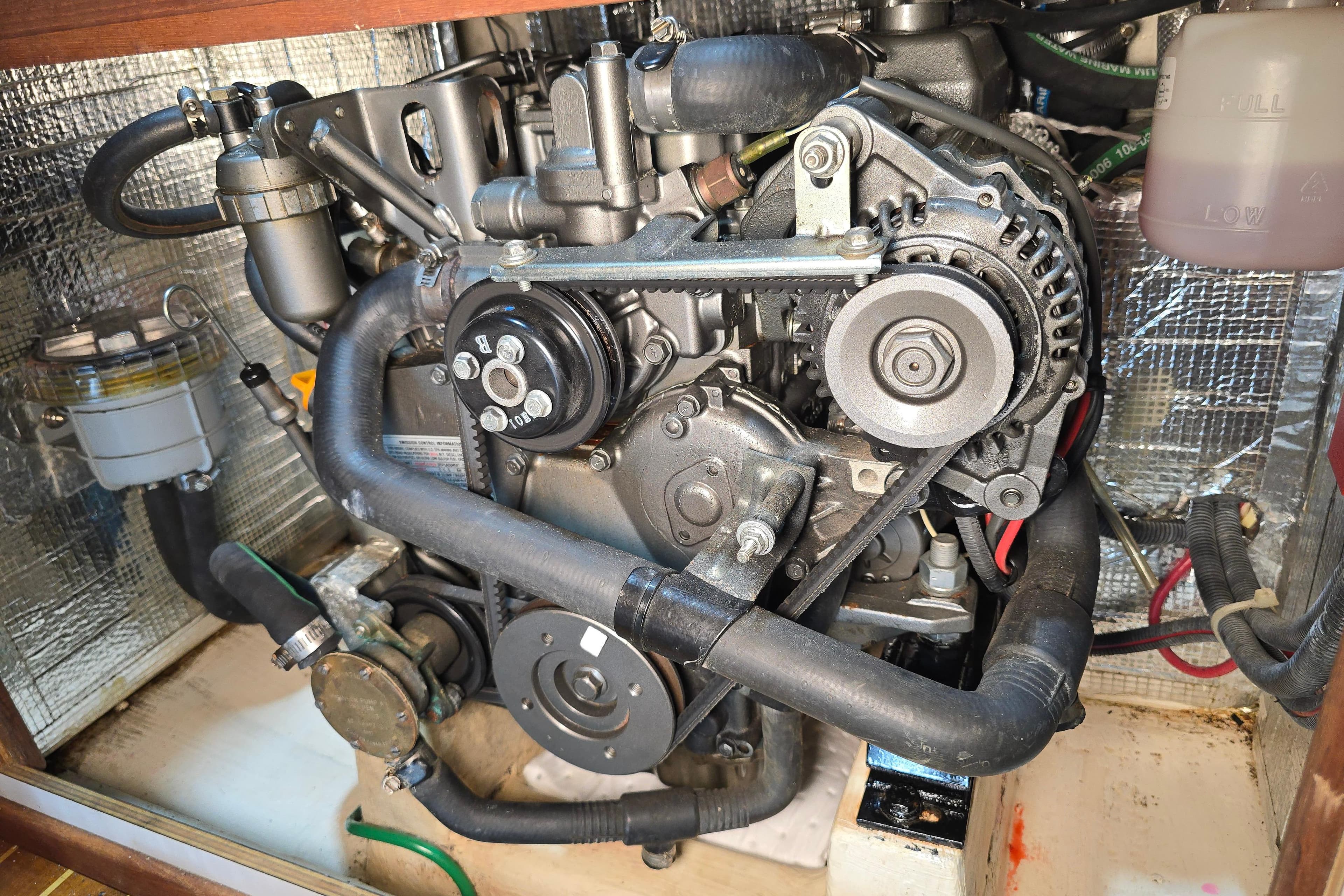 Engine compartment of a 2011 Alerion Express 28 sailboat, showcasing detailed mechanical components.