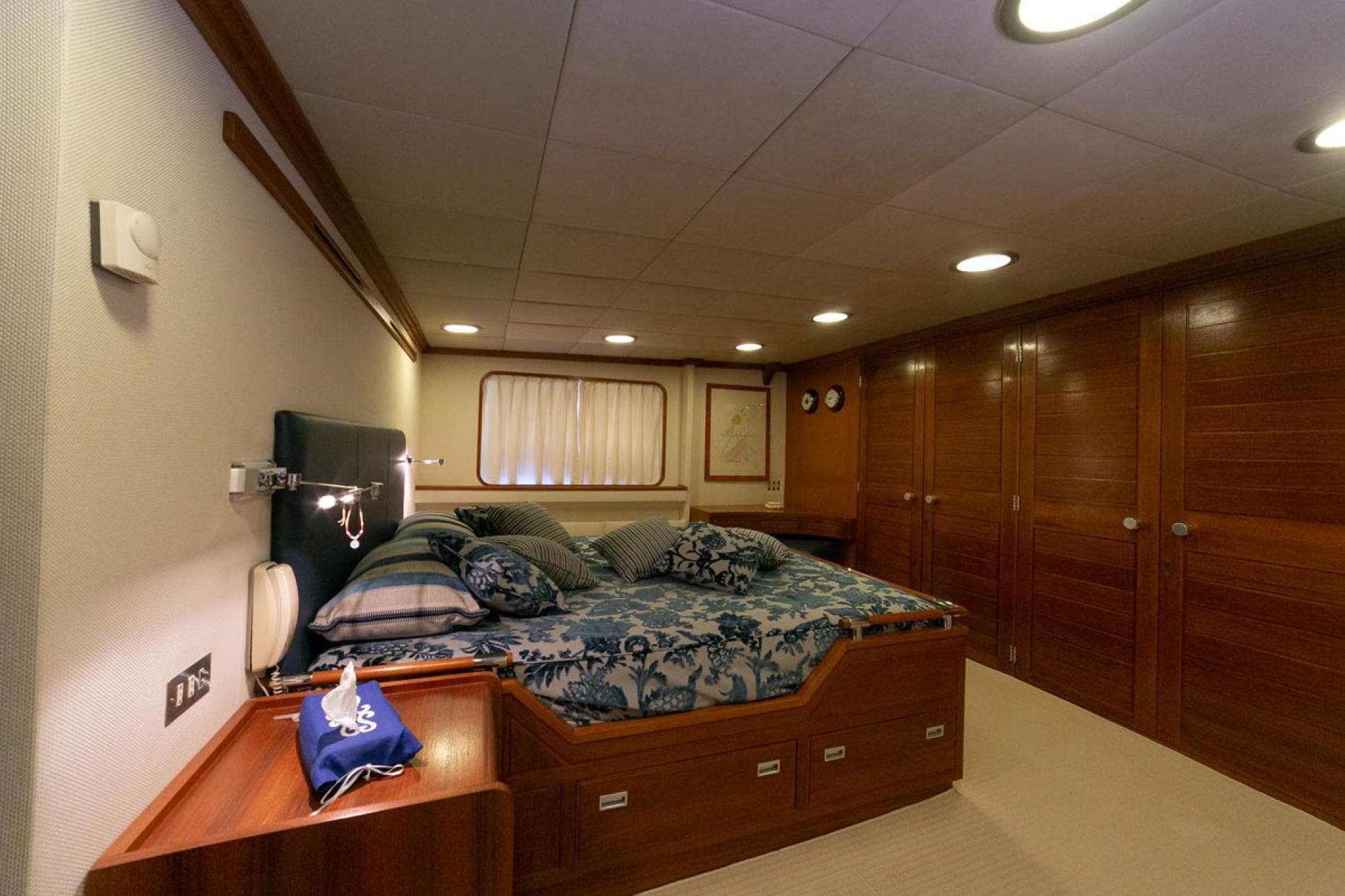 Luxurious 1974 Camper & Nicholsons Custom yacht bedroom with elegant wood paneling and cozy bedding.