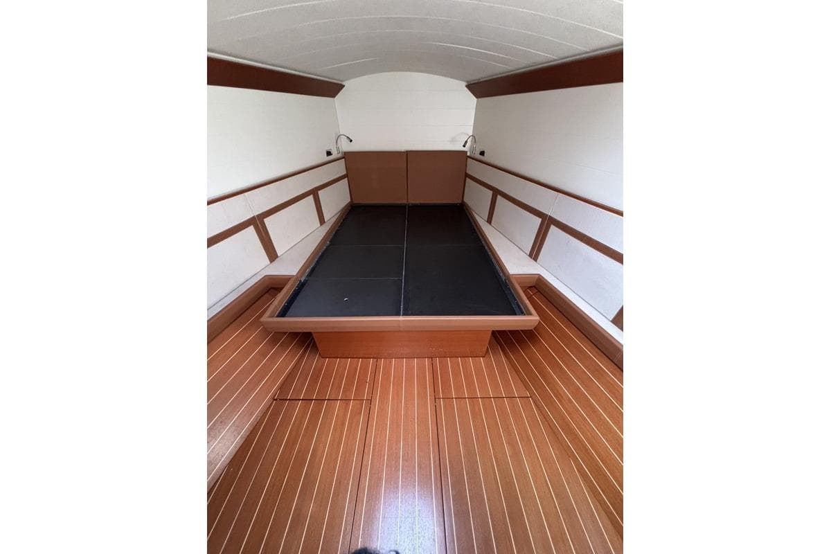 Interior of 2016 Nautor Swan ClubSwan 50 yacht with wooden flooring and sleek design.