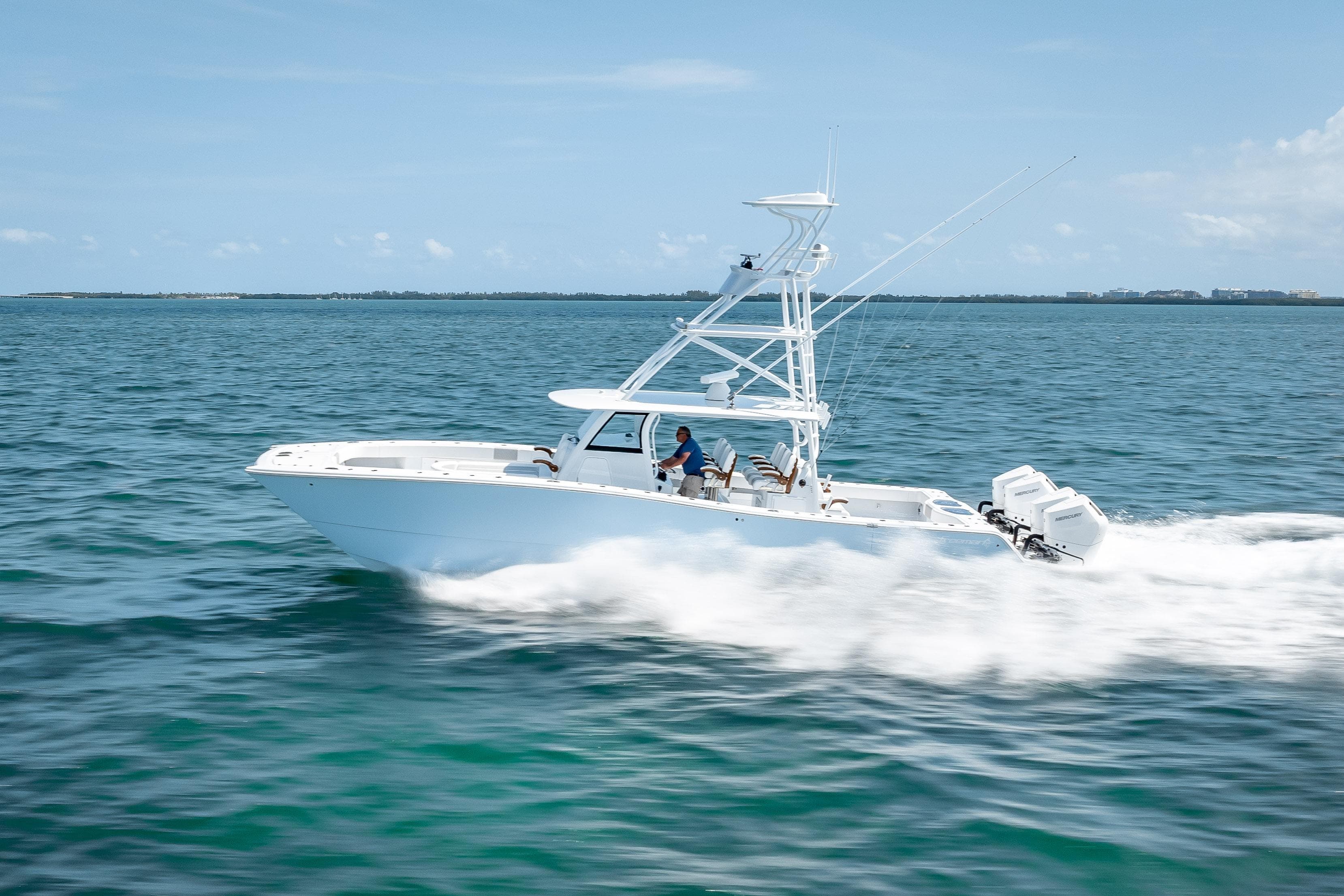 2025 Freeman 43 boat cruising on open water under clear blue skies.