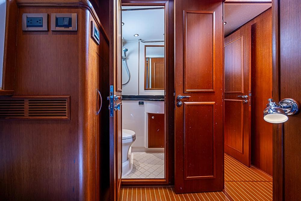 Interior of 2013 Grand Banks 43 Europa yacht, featuring wooden cabinetry and bathroom.