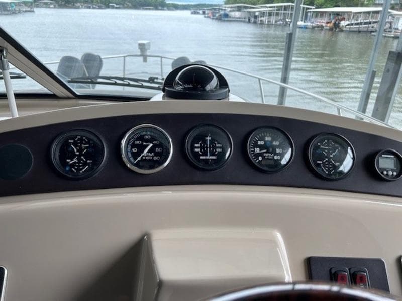 Dashboard of a 2005 Carver Mariner 360 boat with gauges and compass.
