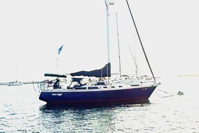 Sailboat Catalina 34, 1992 model, anchored on calm water.