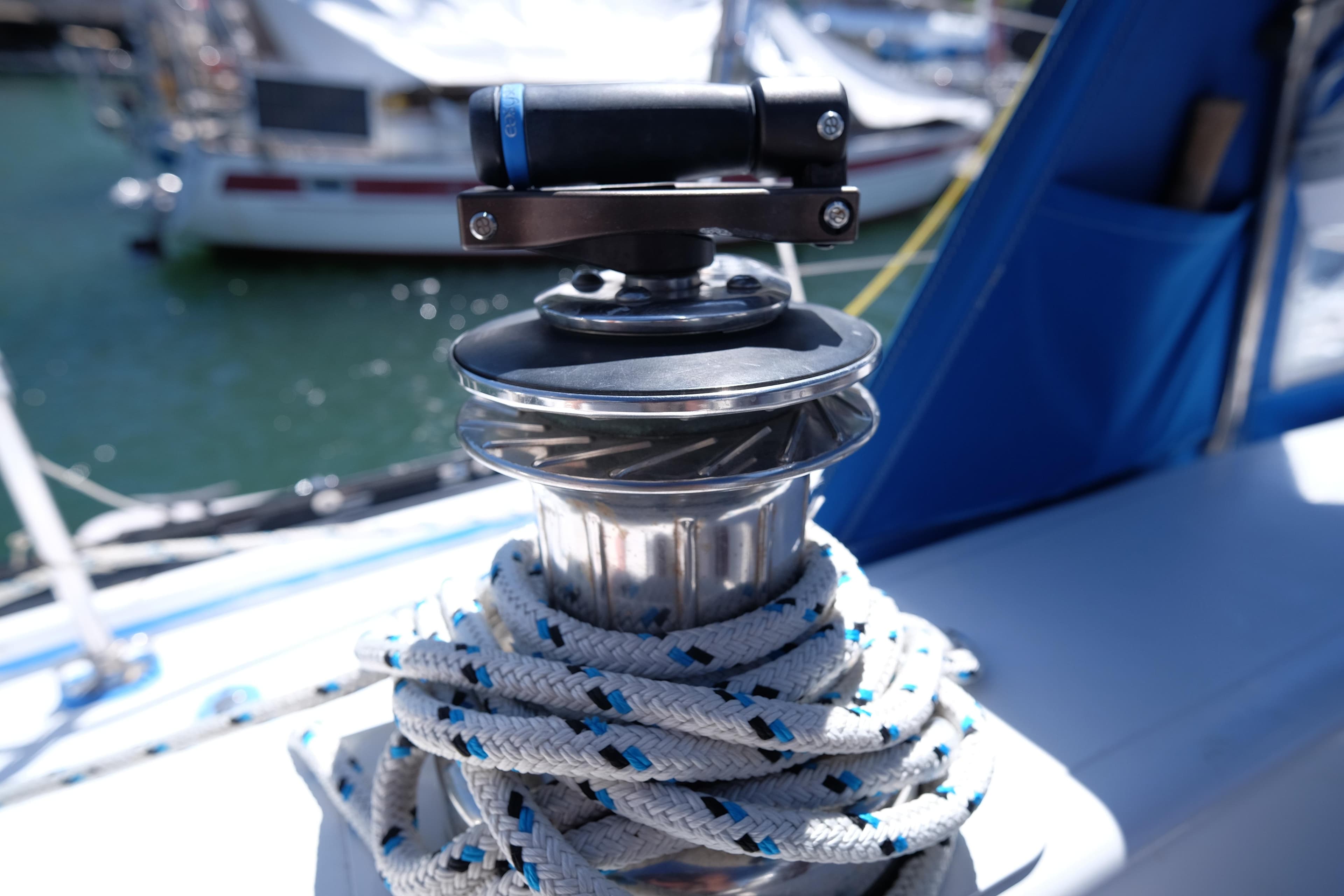 Sailboat winch with rope on 1981 Corbin 39, docked in marina.