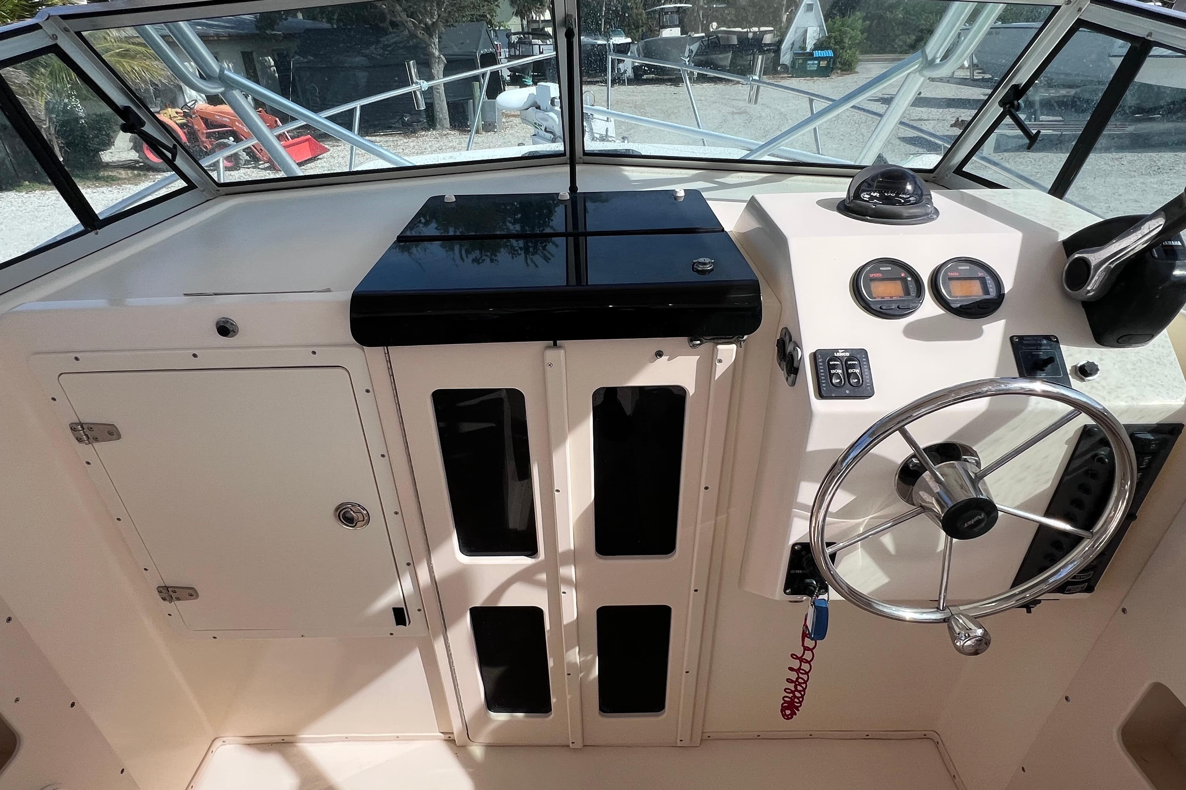 2005 Parker 2510 Walkaround boat dashboard with steering wheel and gauges.