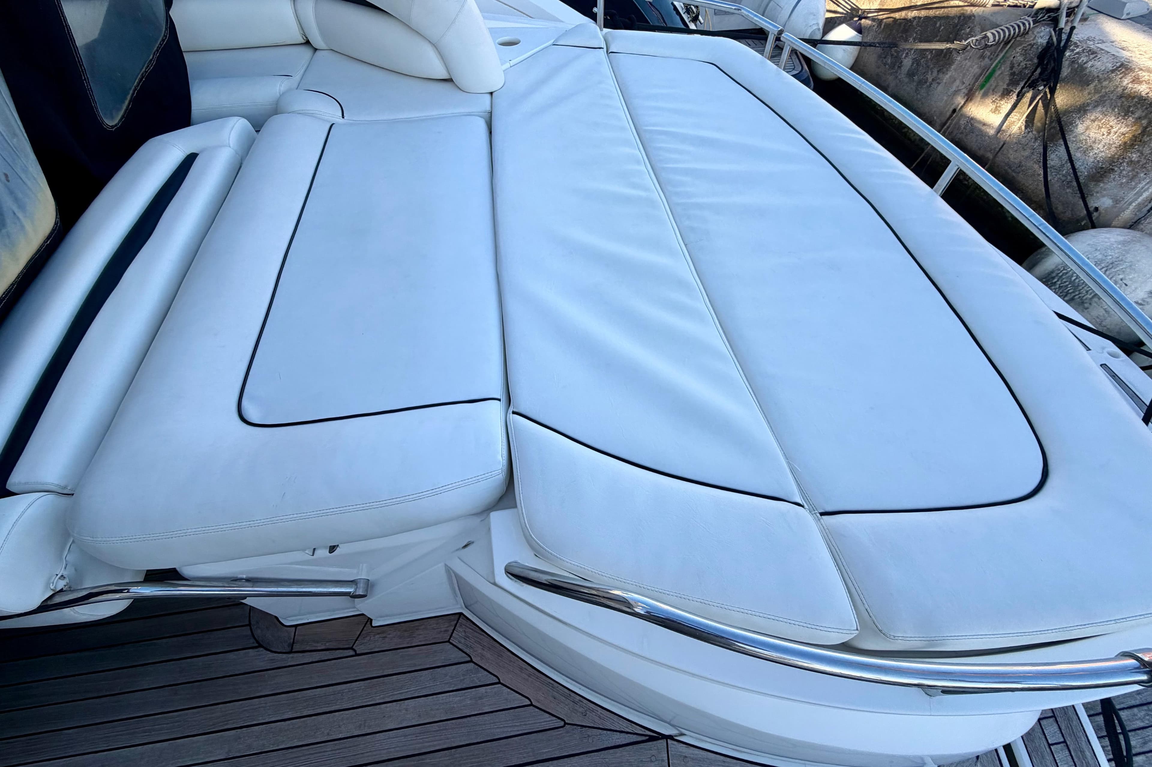 Sunseeker Portofino 47 yacht, 2006 model, featuring luxurious white cushioned seating area.