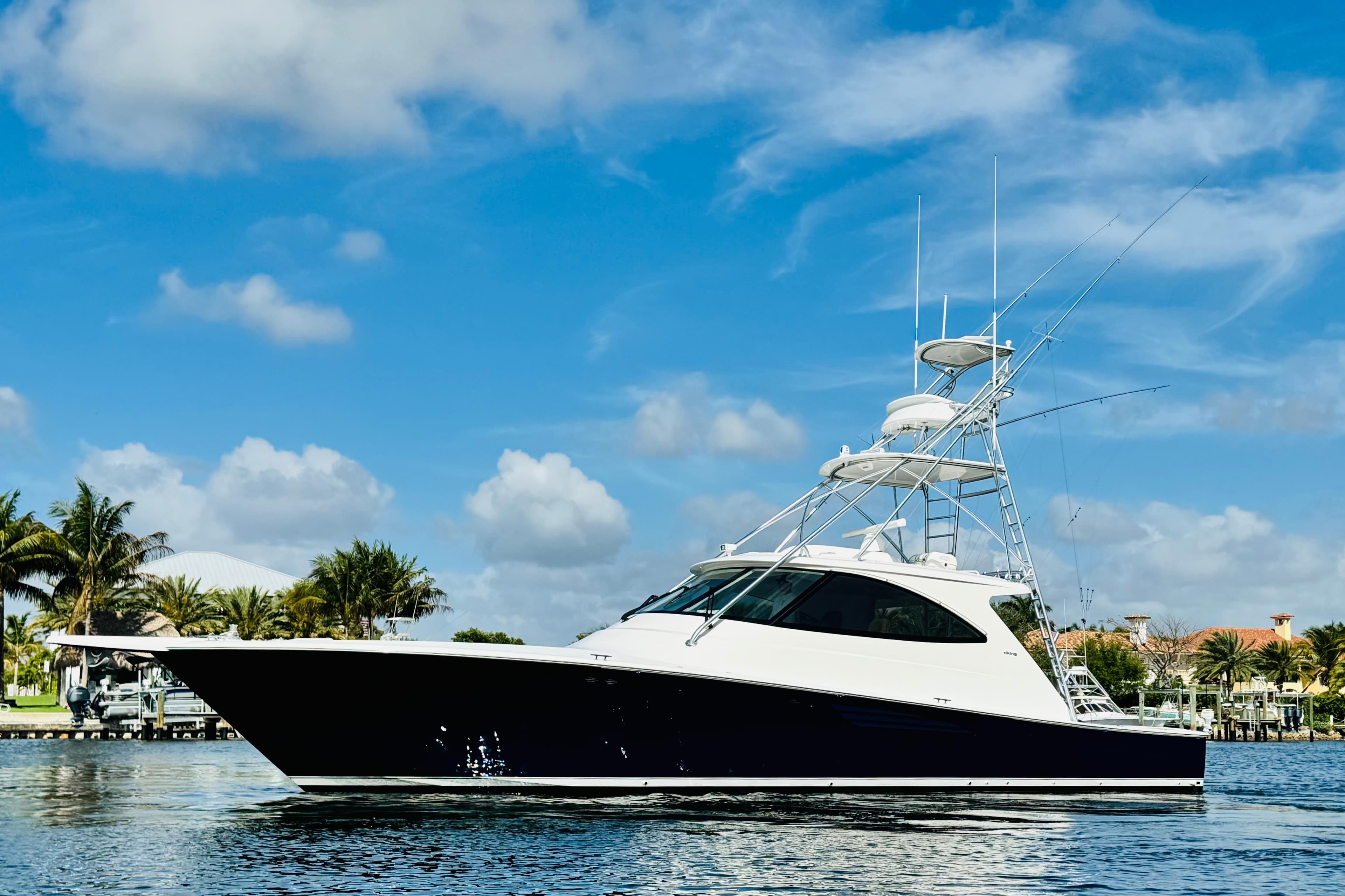 2017 Viking 52 Sport Tower yacht cruising under a clear blue sky.
