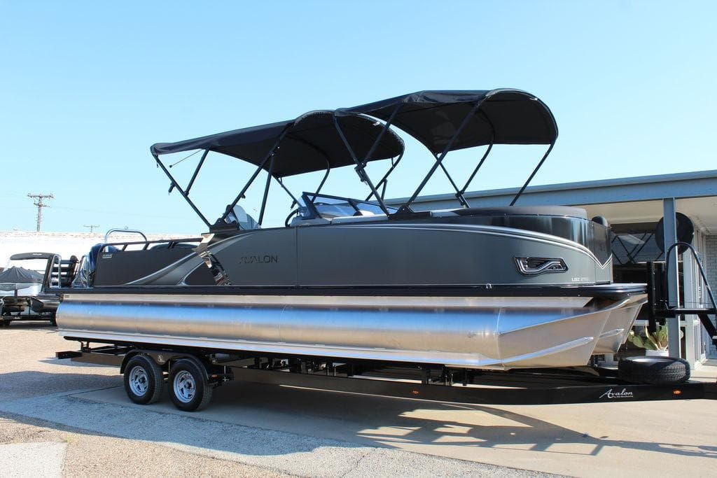 2026 Avalon LSZ Versatile Rear Bench Windshield 27 FT pontoon boat on trailer.