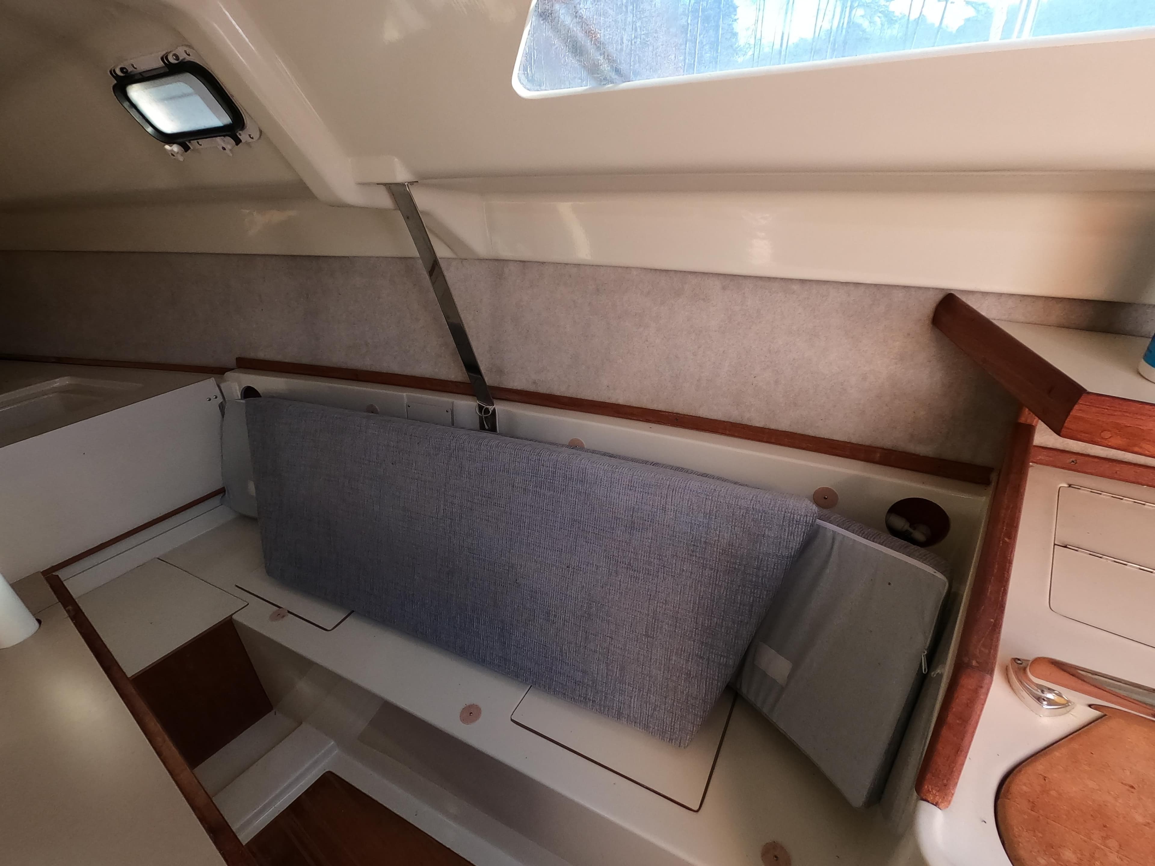 Interior of a 1992 Hunter 27 sailboat with seating area.