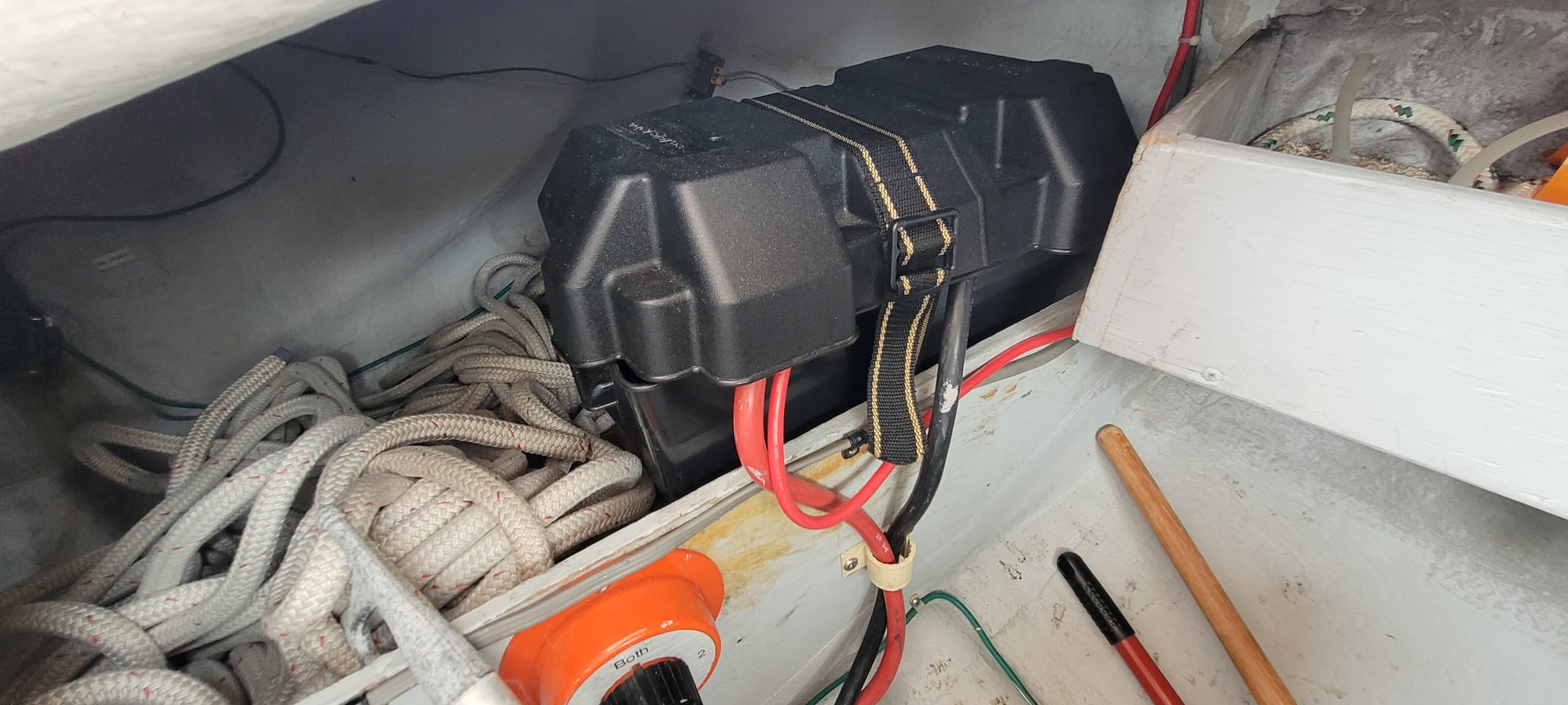 Battery compartment of a 1985 Mason 33 Sloop with cables and ropes.