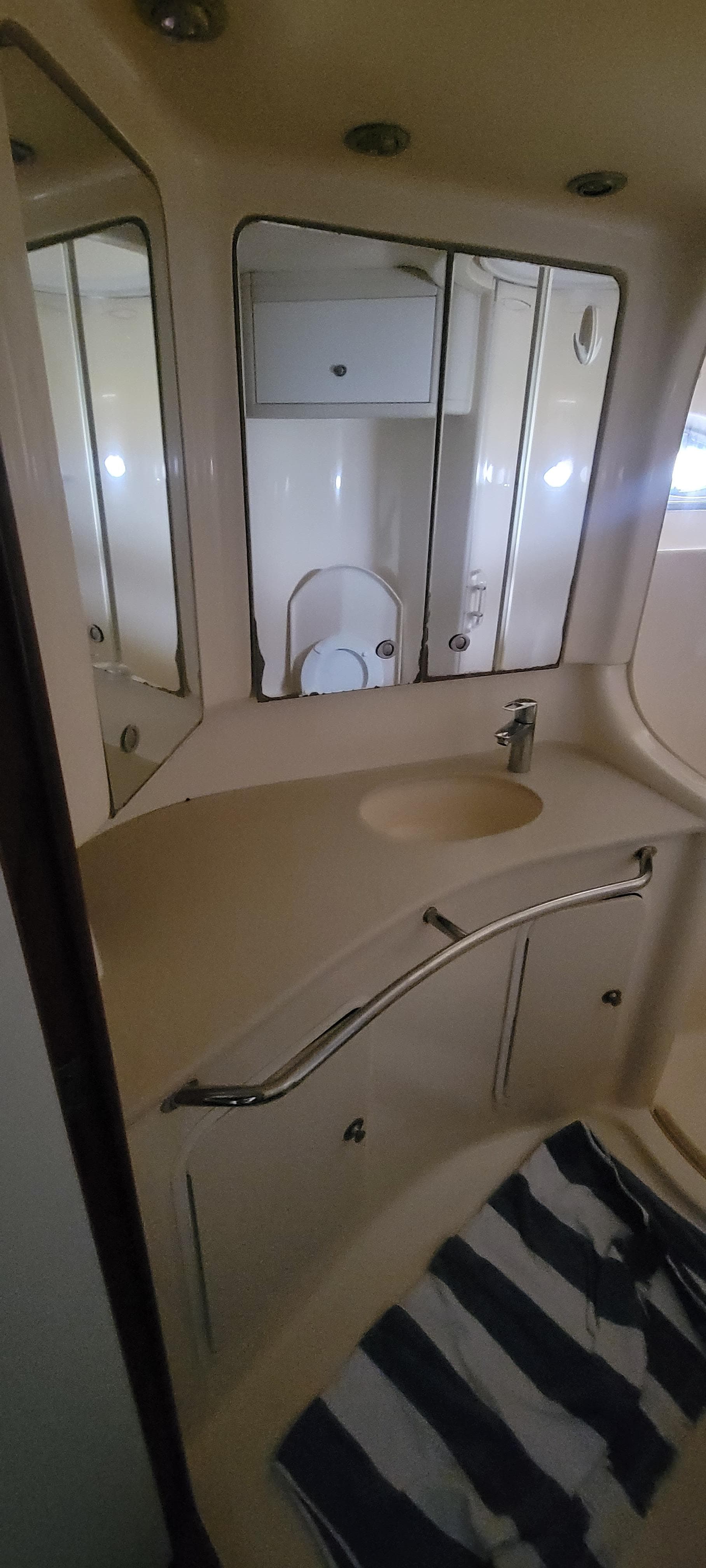 Bathroom vanity area in 2004 Sea Ray 480 Sedan Bridge yacht.