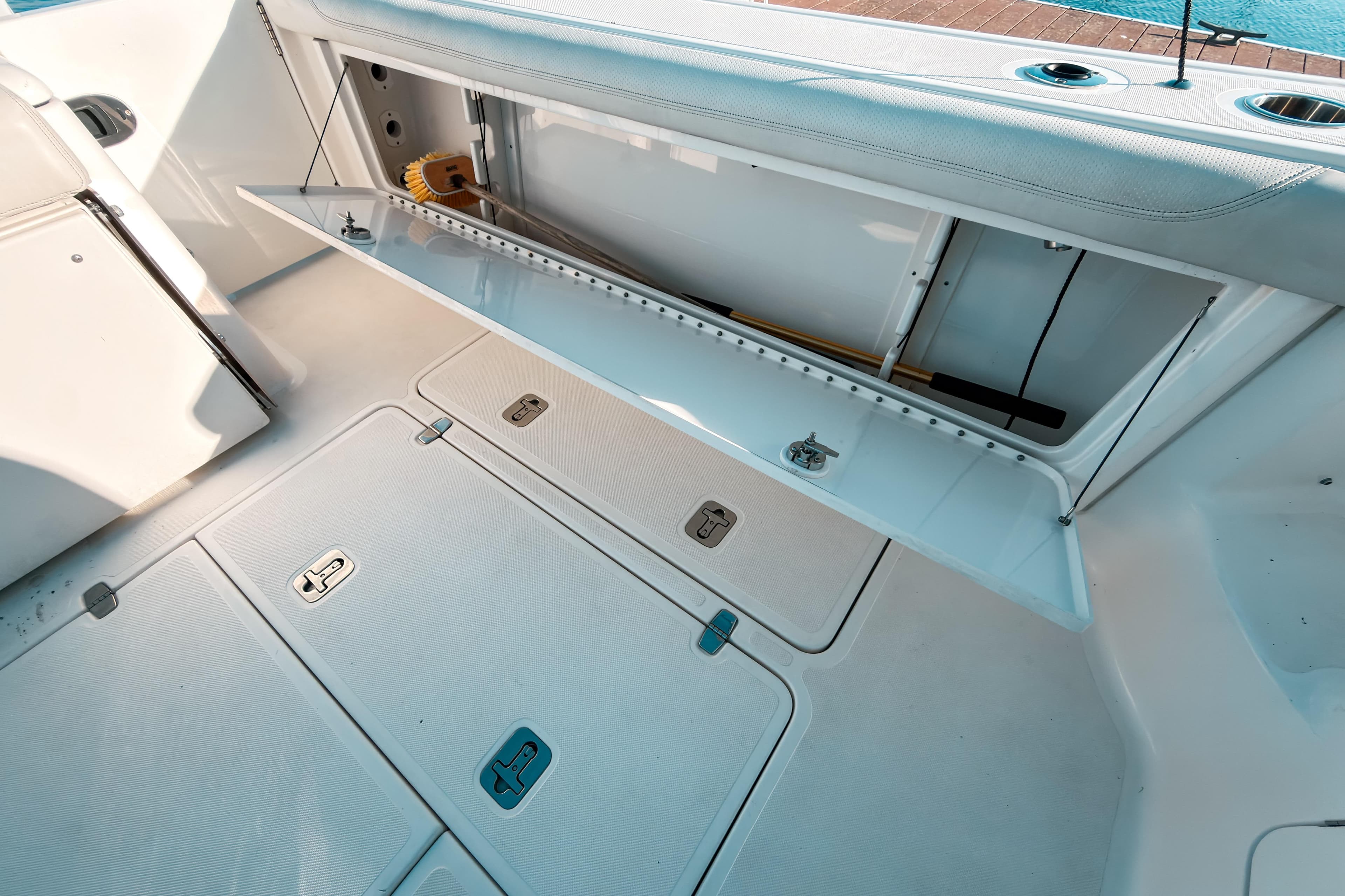 2021 Pursuit OS 385 Offshore boat storage compartment with open hatch and clean deck.