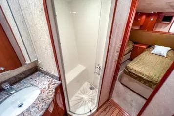 Luxurious 2007 Hatteras 68 Convertible yacht interior with bathroom and bedroom.