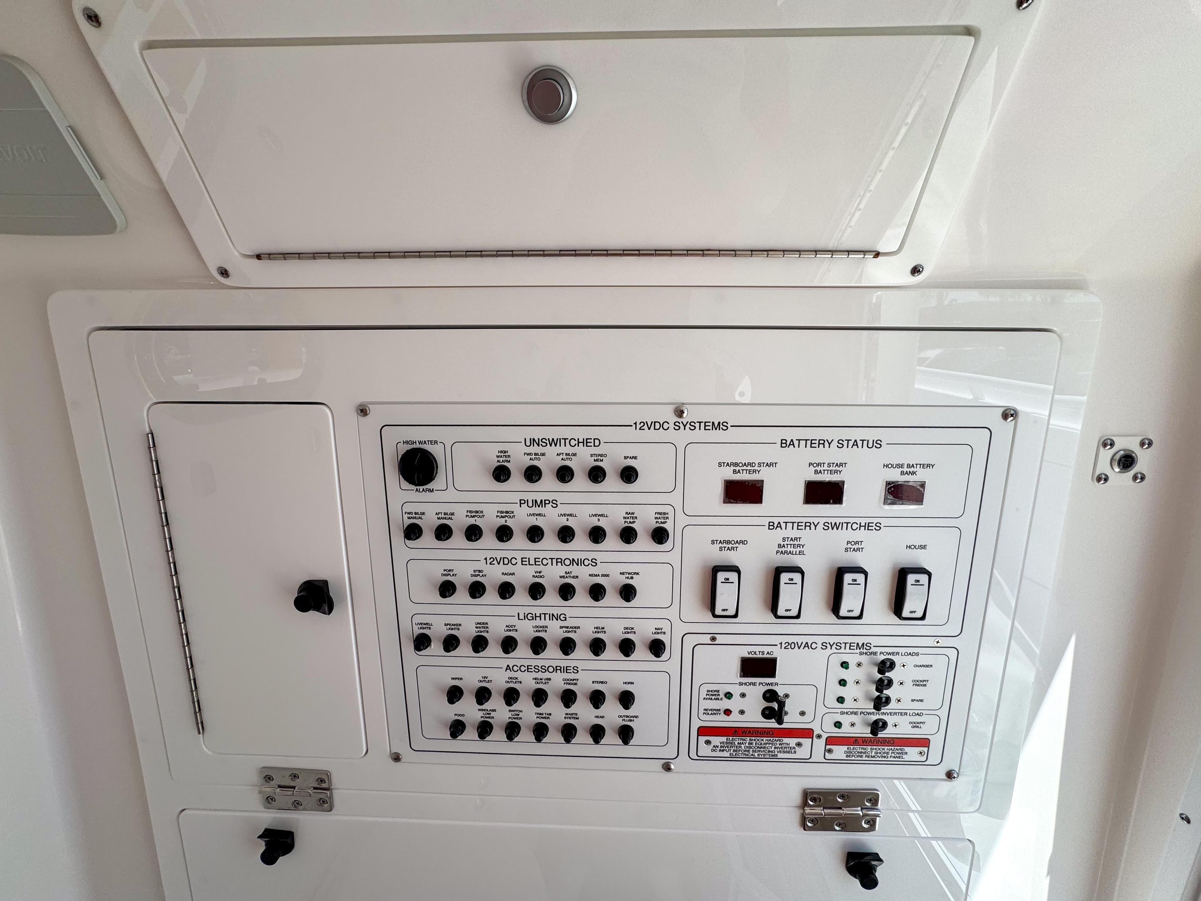 Control panel of 2025 Edgewater 325CC boat, featuring switches and battery status indicators.