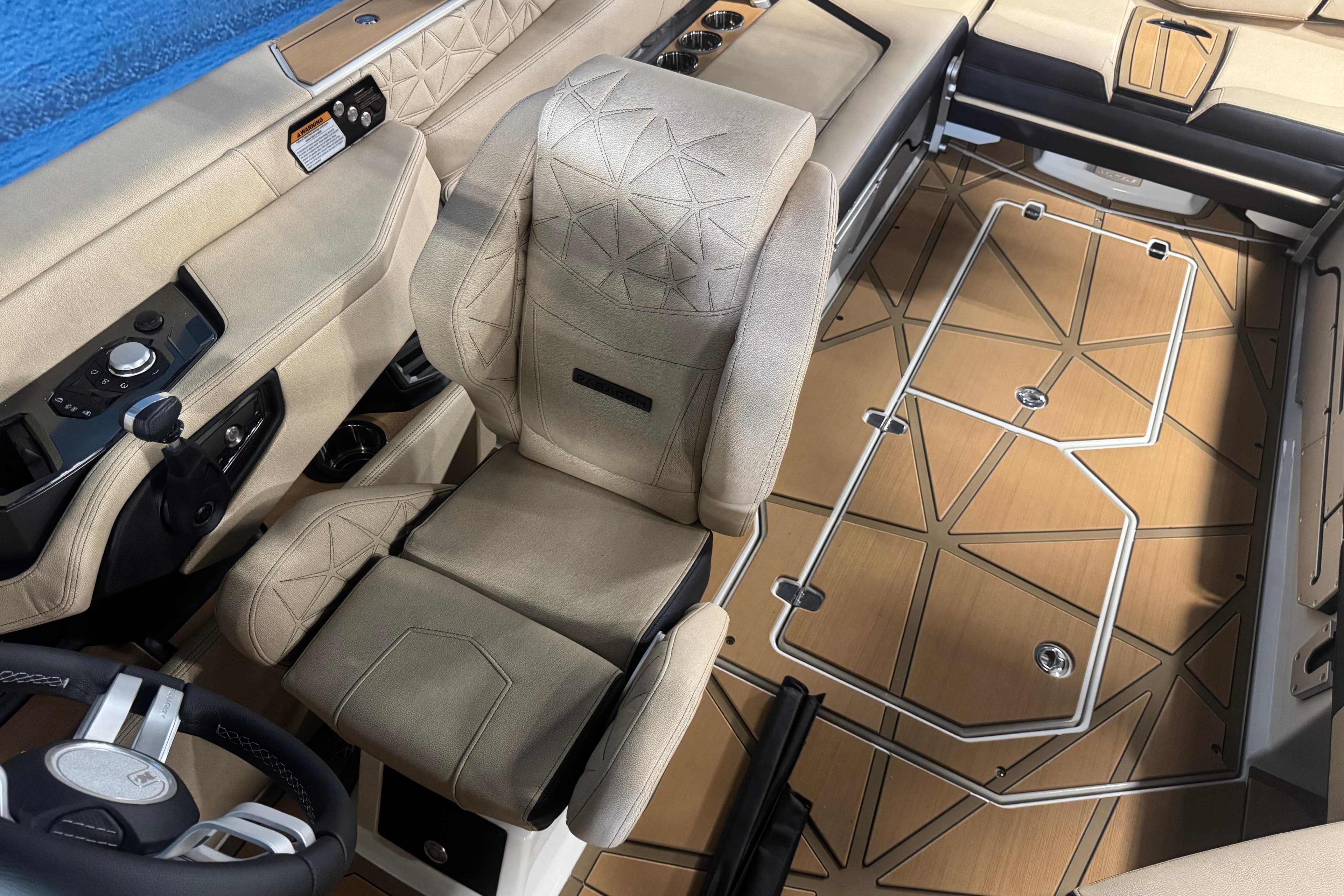 2026 Nautique Super Air Nautique G25 Paragon interior with beige seating and geometric flooring.