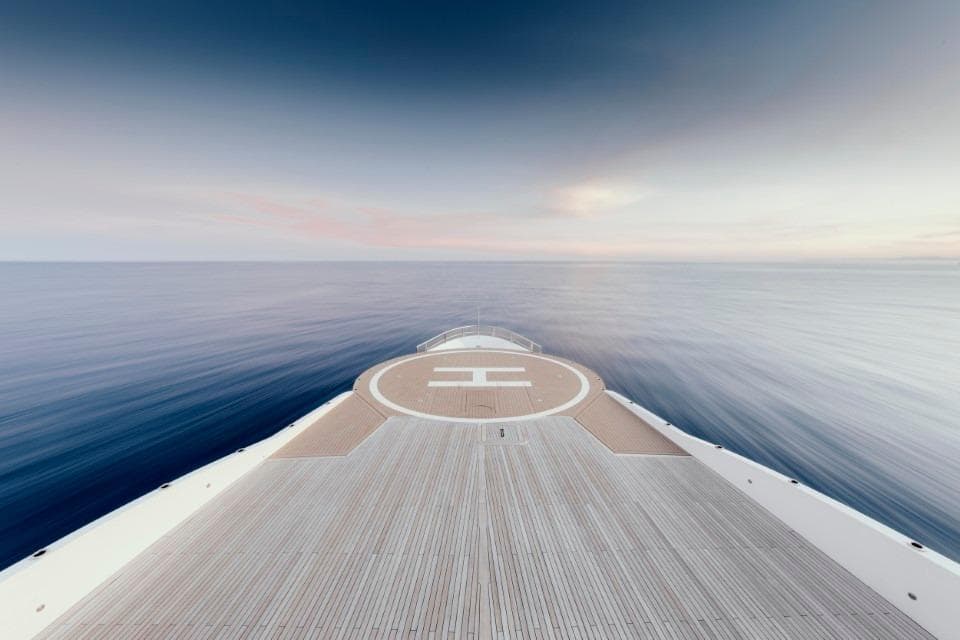 Austal Displacement yacht deck, 2007, with helipad, overlooking calm ocean and sky.