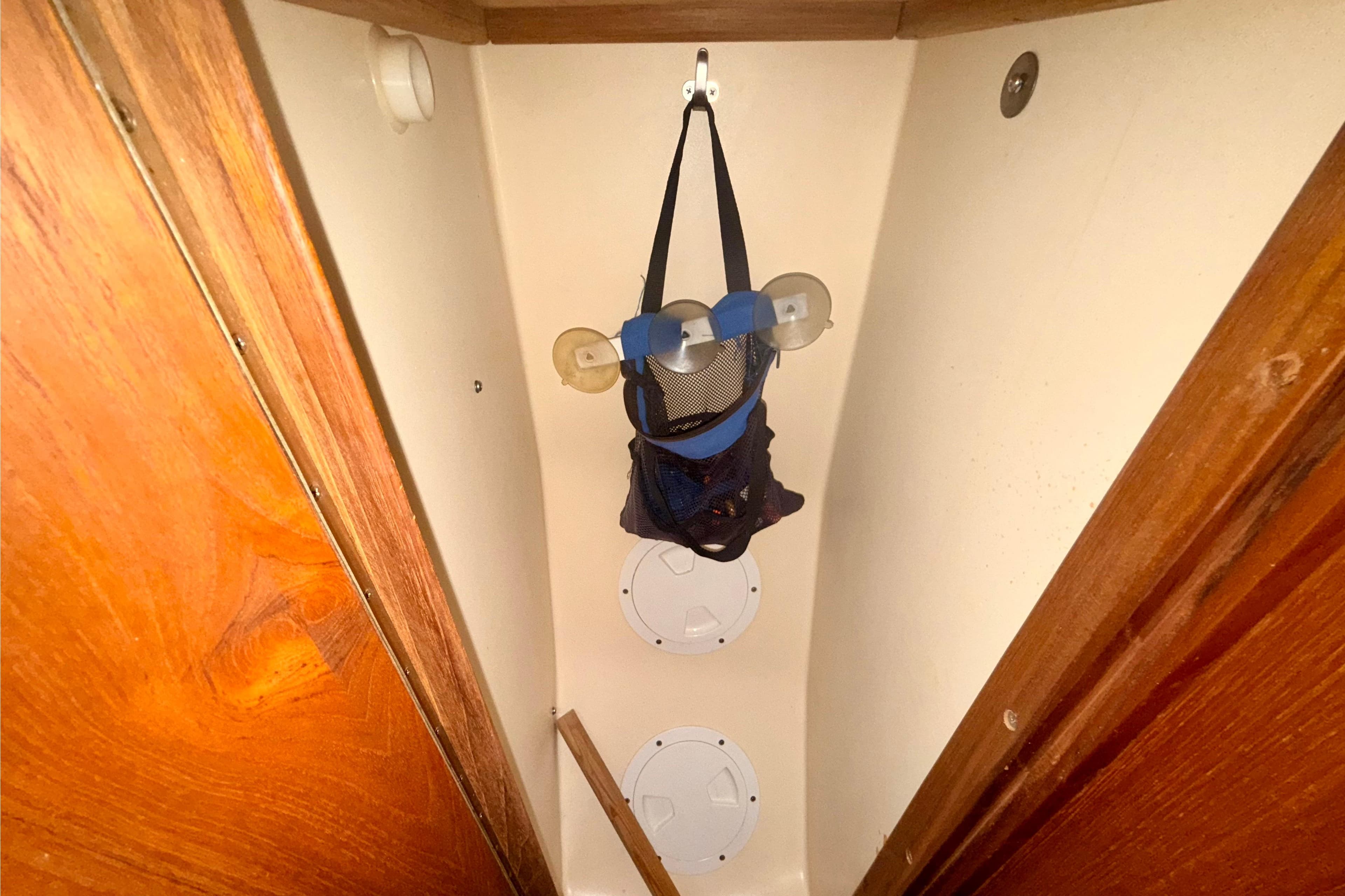 Storage area inside a 1996 Hunter 376 boat with hanging organizer.