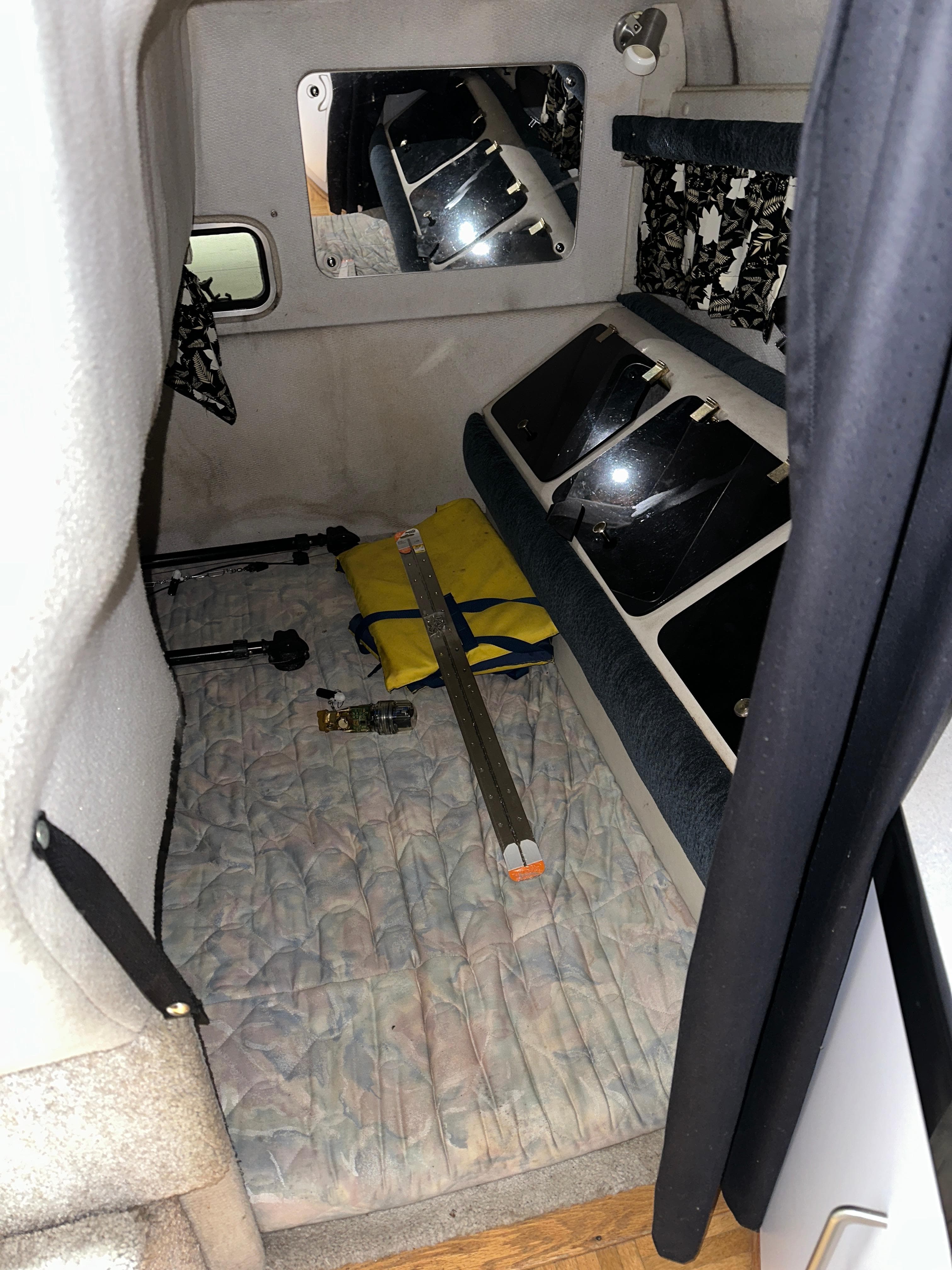 1993 Rinker 280 Fiesta Vee cabin interior with bed and storage compartments.