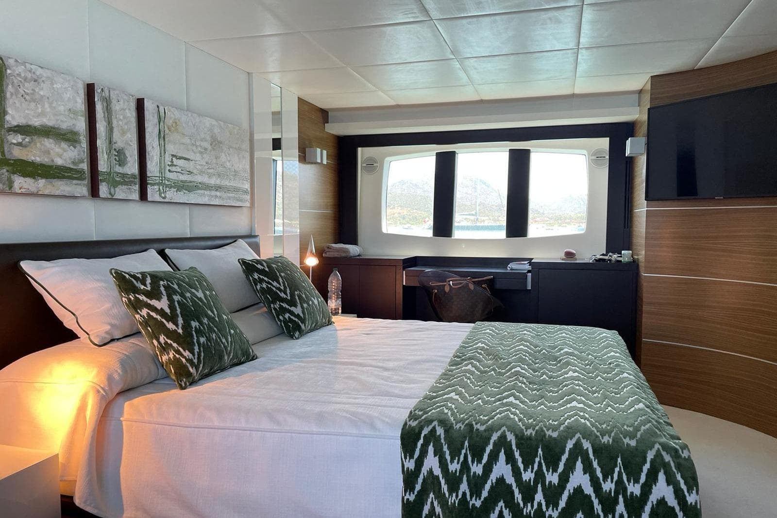 Luxurious bedroom interior of 2008 Astondoa 76 GLX yacht with modern decor and large window.