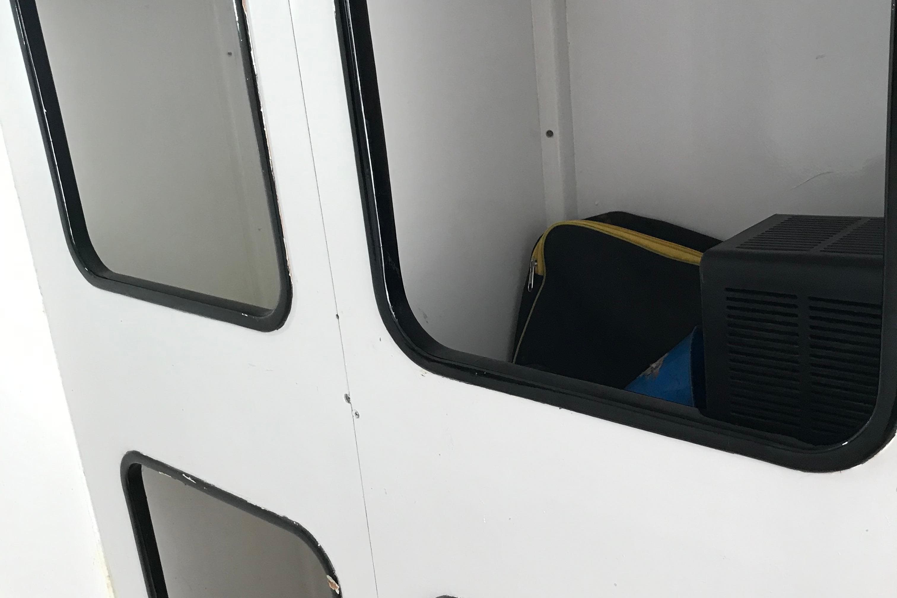 Interior of a 1993 Nelson Marek 43 boat with storage compartment.