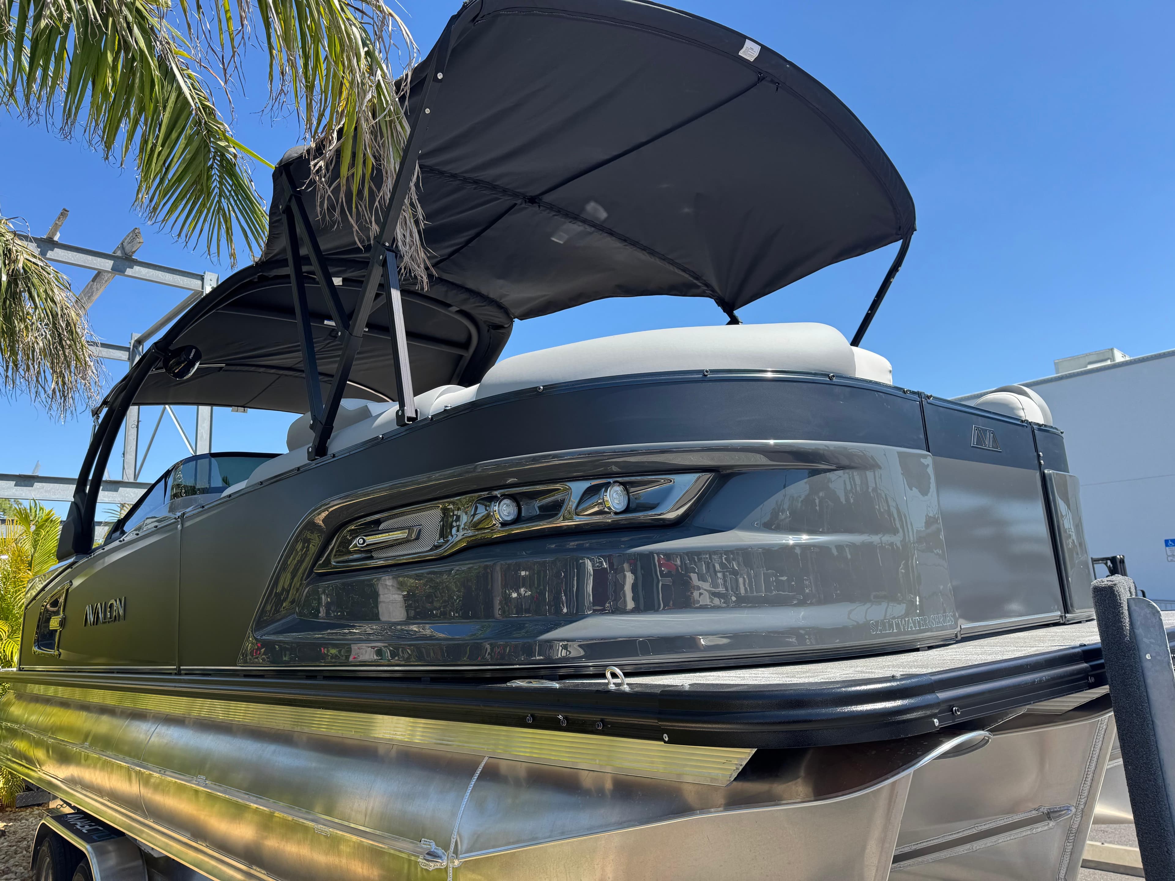 2025 Avalon Excalibur 27' pontoon boat with canopy, sleek design under clear blue sky.