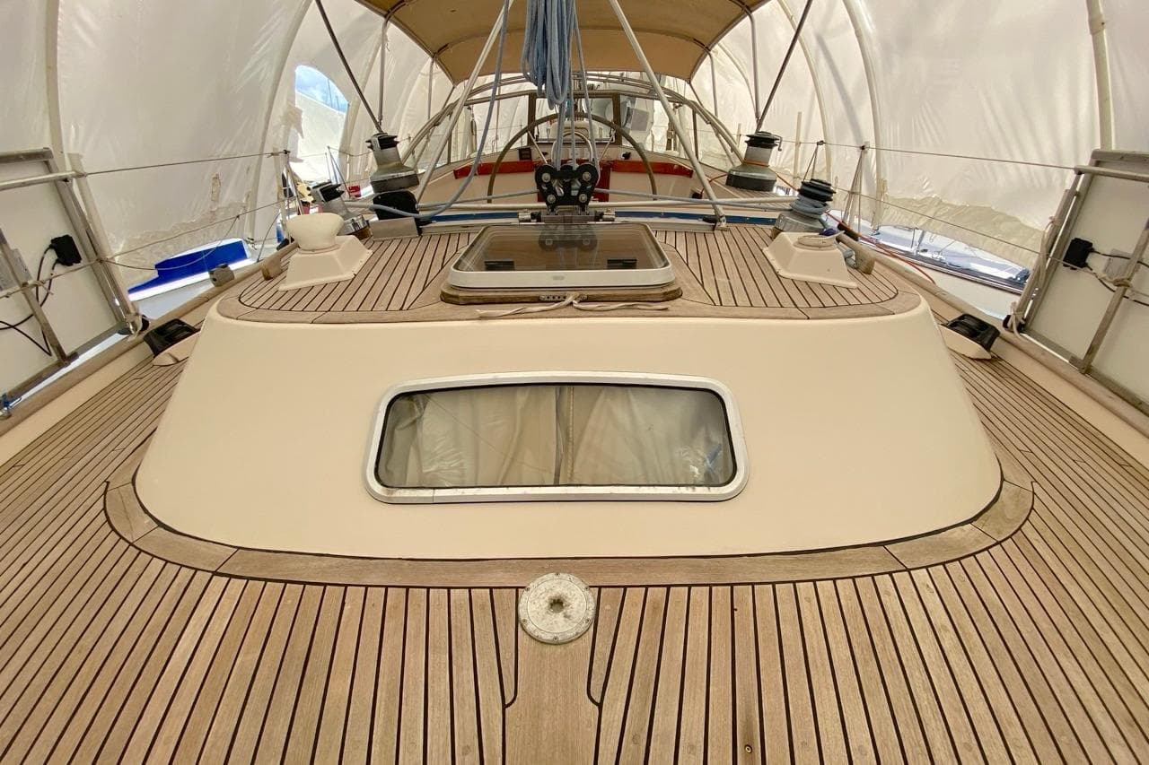 1992 Hallberg-Rassy 45 yacht deck with teak wood finish and cabin window.