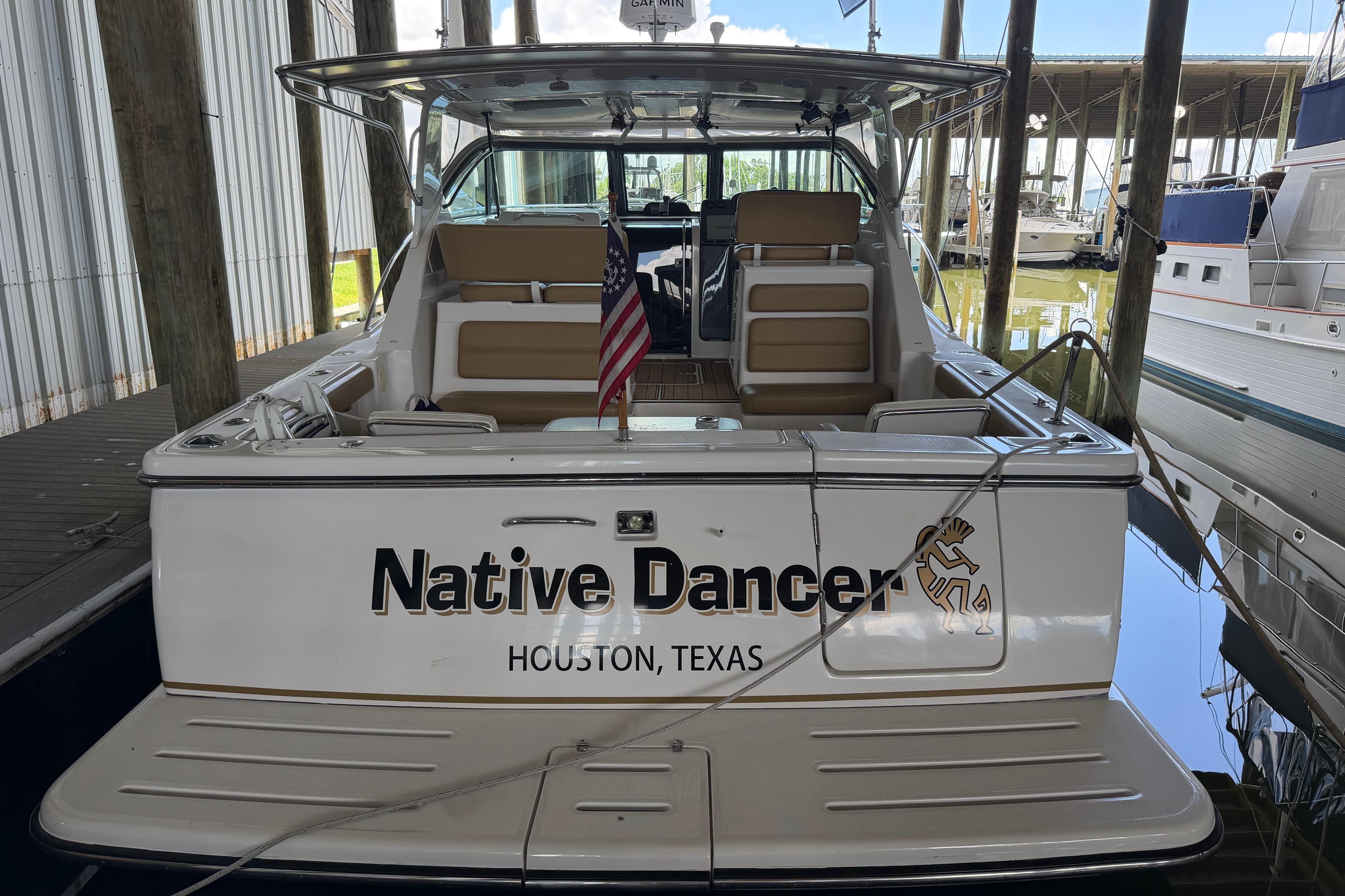 2002 Tiara Yachts 3800 Open docked, named "Native Dancer," in Houston, Texas marina.