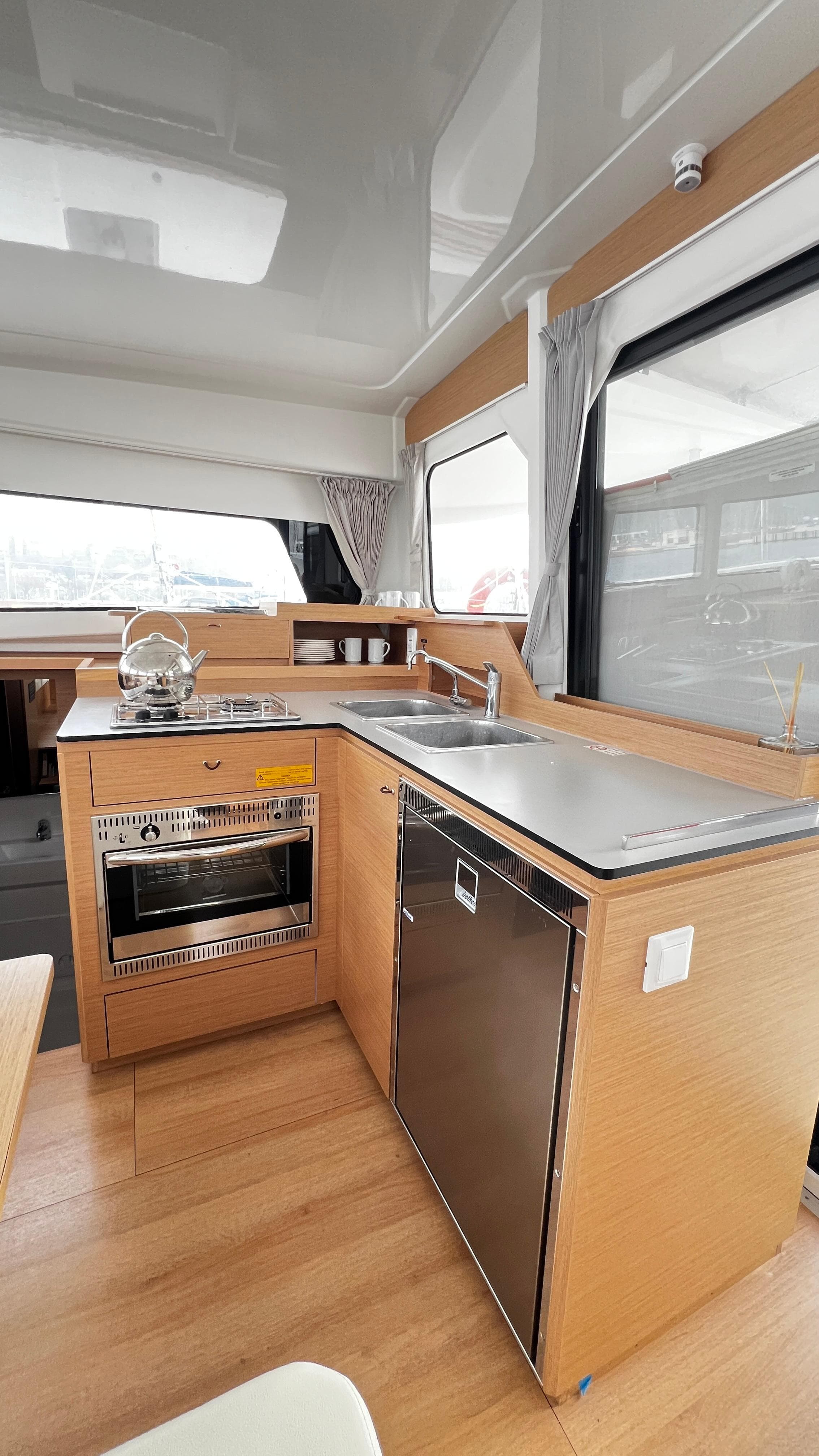 Modern kitchen in 2022 Excess 11 yacht with sleek appliances and wooden cabinetry.