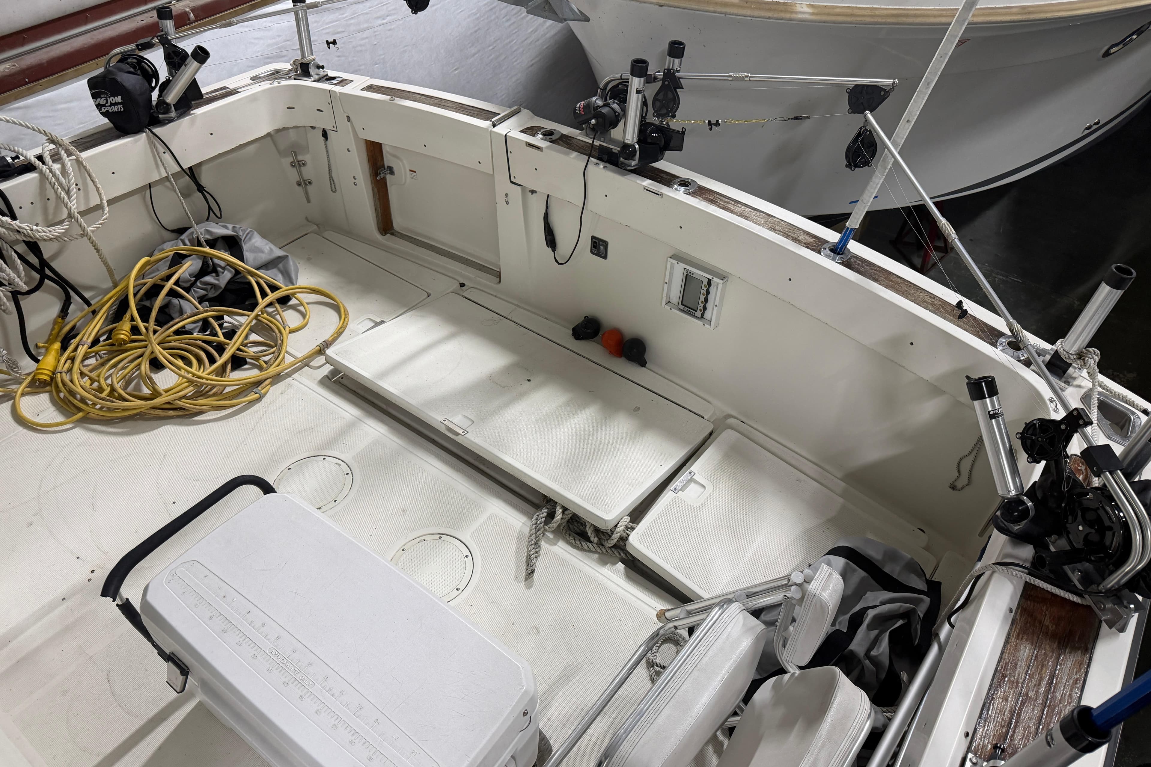 1989 Tiara Yachts 3600 Open boat deck with fishing gear and storage compartments.