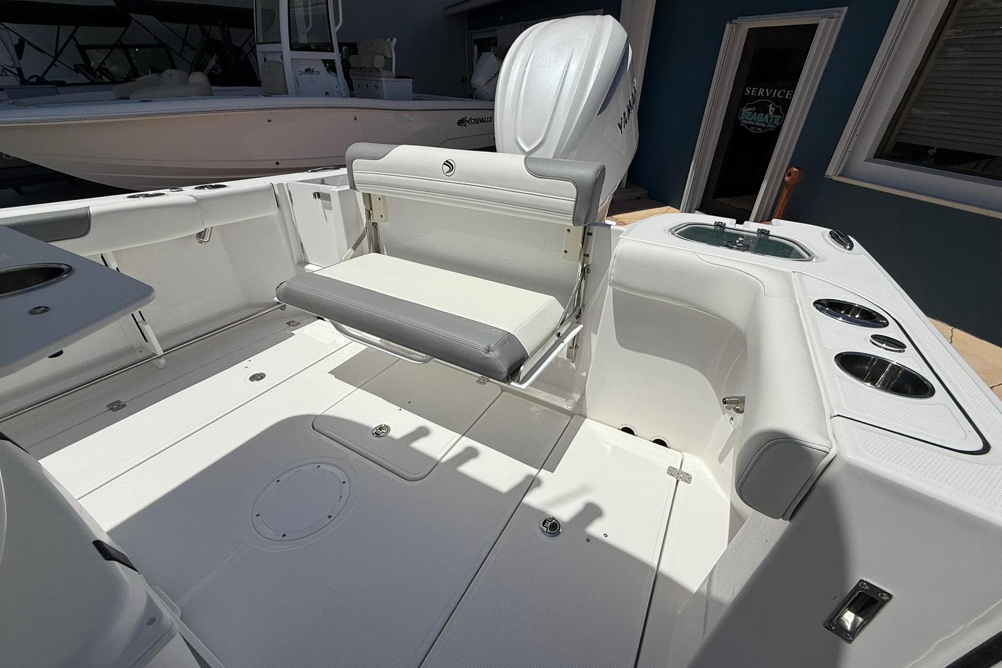 2026 Edgewater 250CC boat interior with seating and cup holders, showcasing modern design.