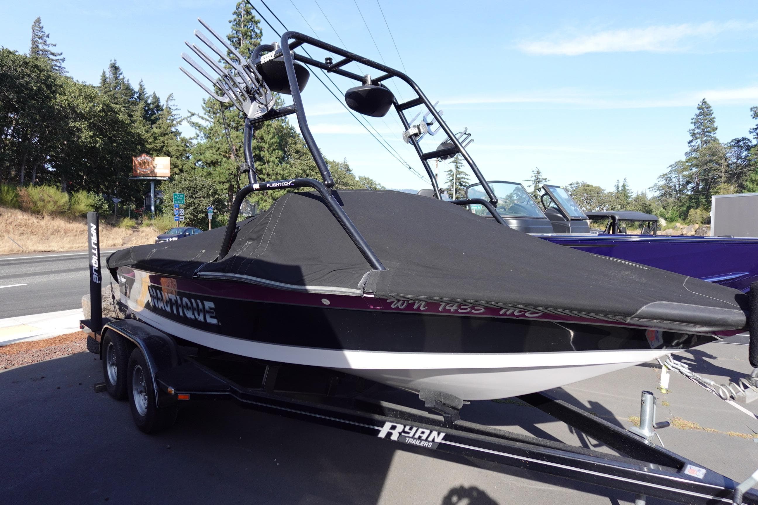 1993 Correct Craft Ski Nautique 200 Closed Bow boat on trailer, covered and parked outdoors.