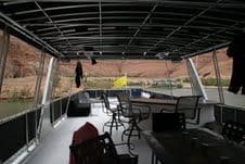 2009 Sumerset Stargazer Trip 10 houseboat interior with chairs and table, scenic river view.