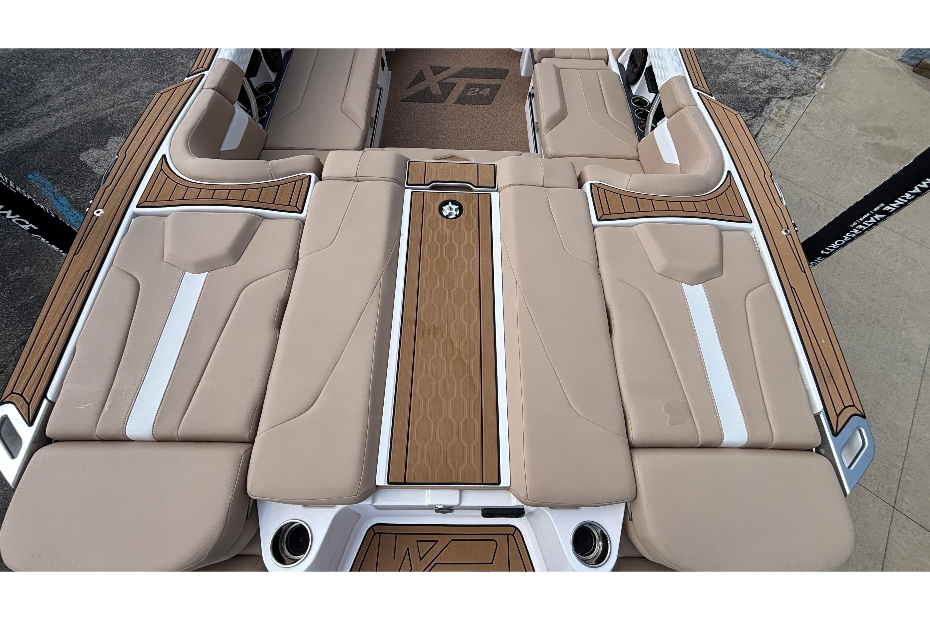 2024 MasterCraft XT24 boat interior with beige seating and wood accents.