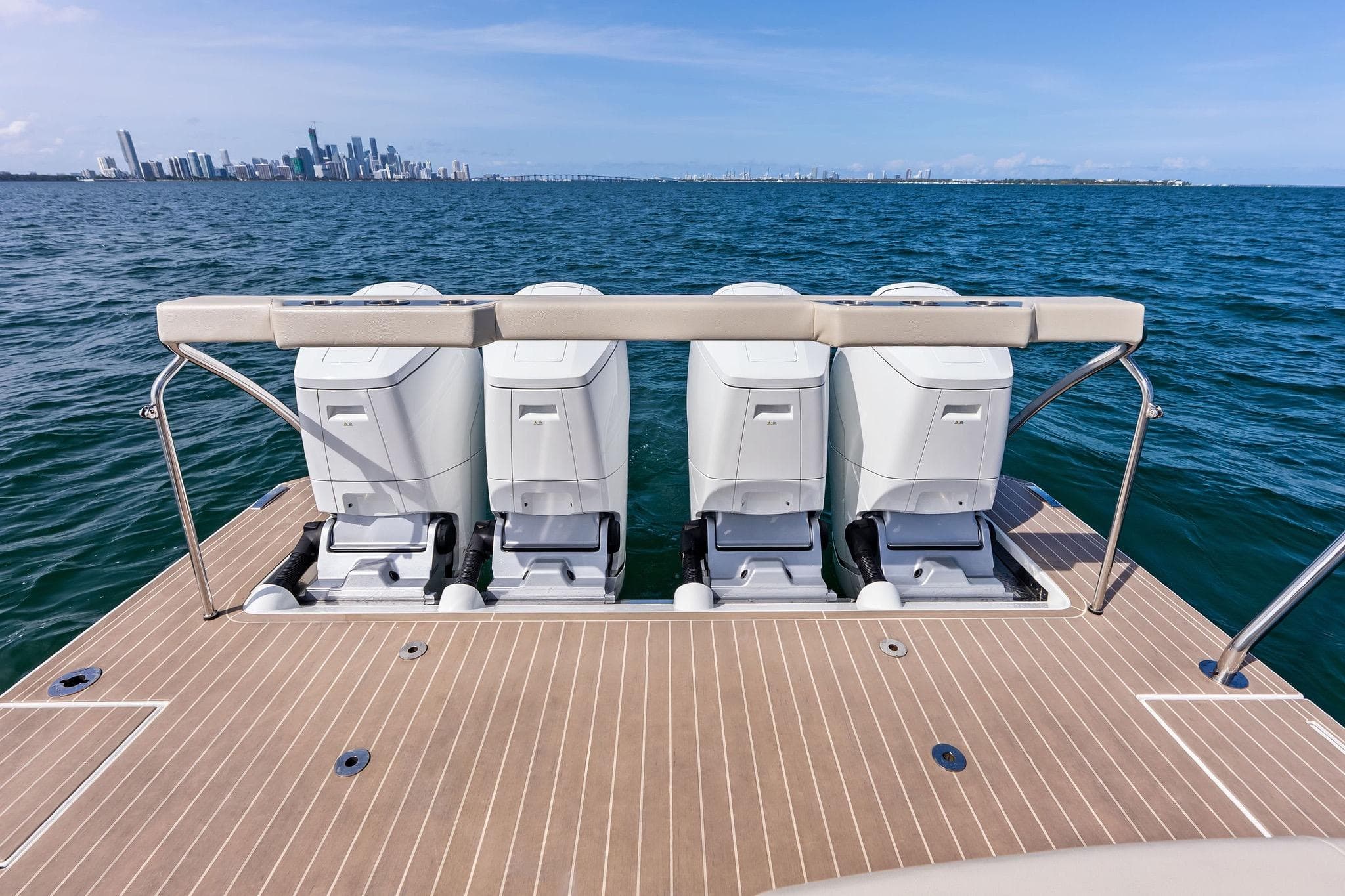2025 Formula 500 Super Sport Crossover boat with four engines, ocean view, city skyline background.