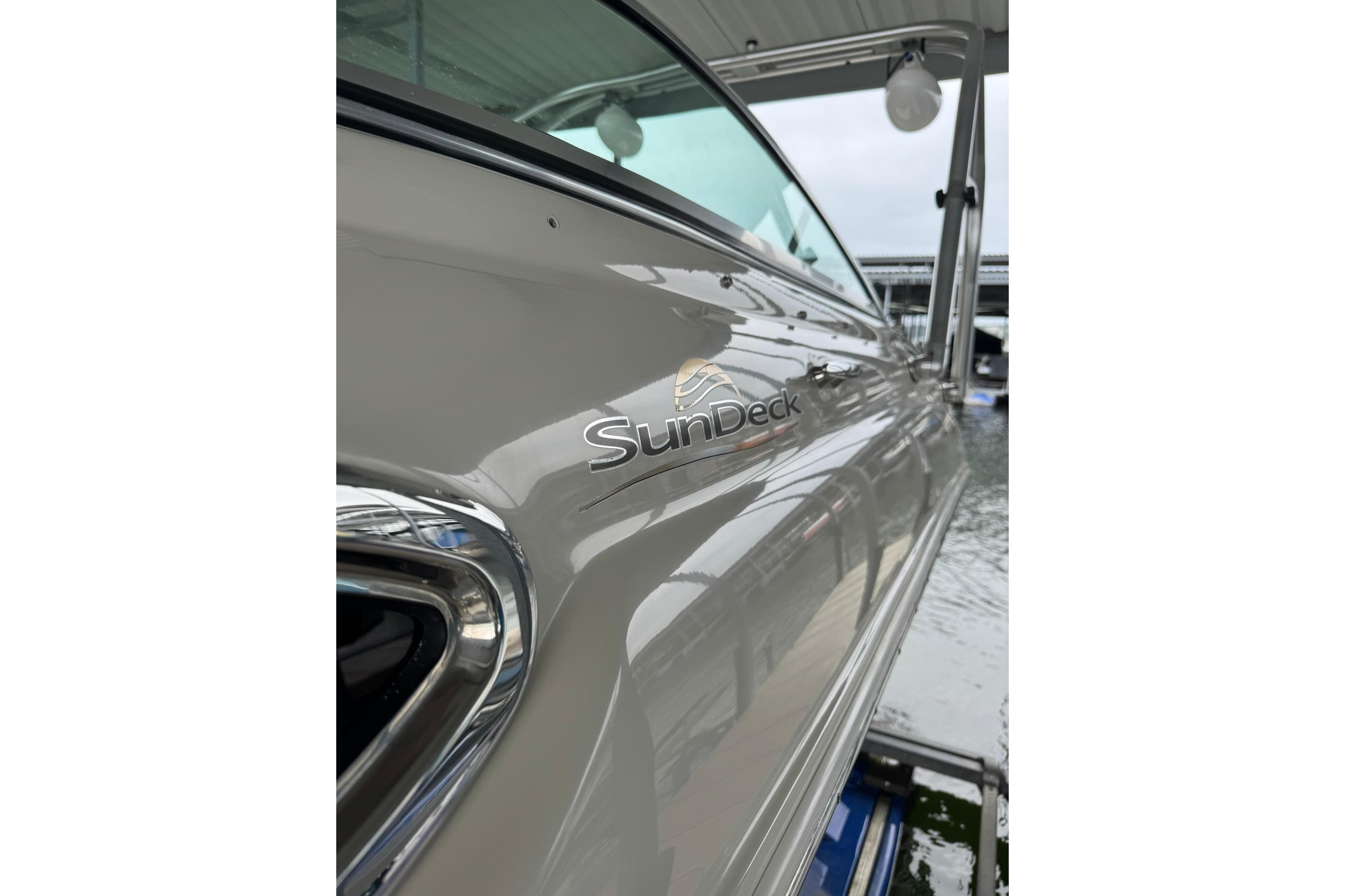 2008 Sea Ray 240 Sundeck boat docked, showcasing sleek design and branding.