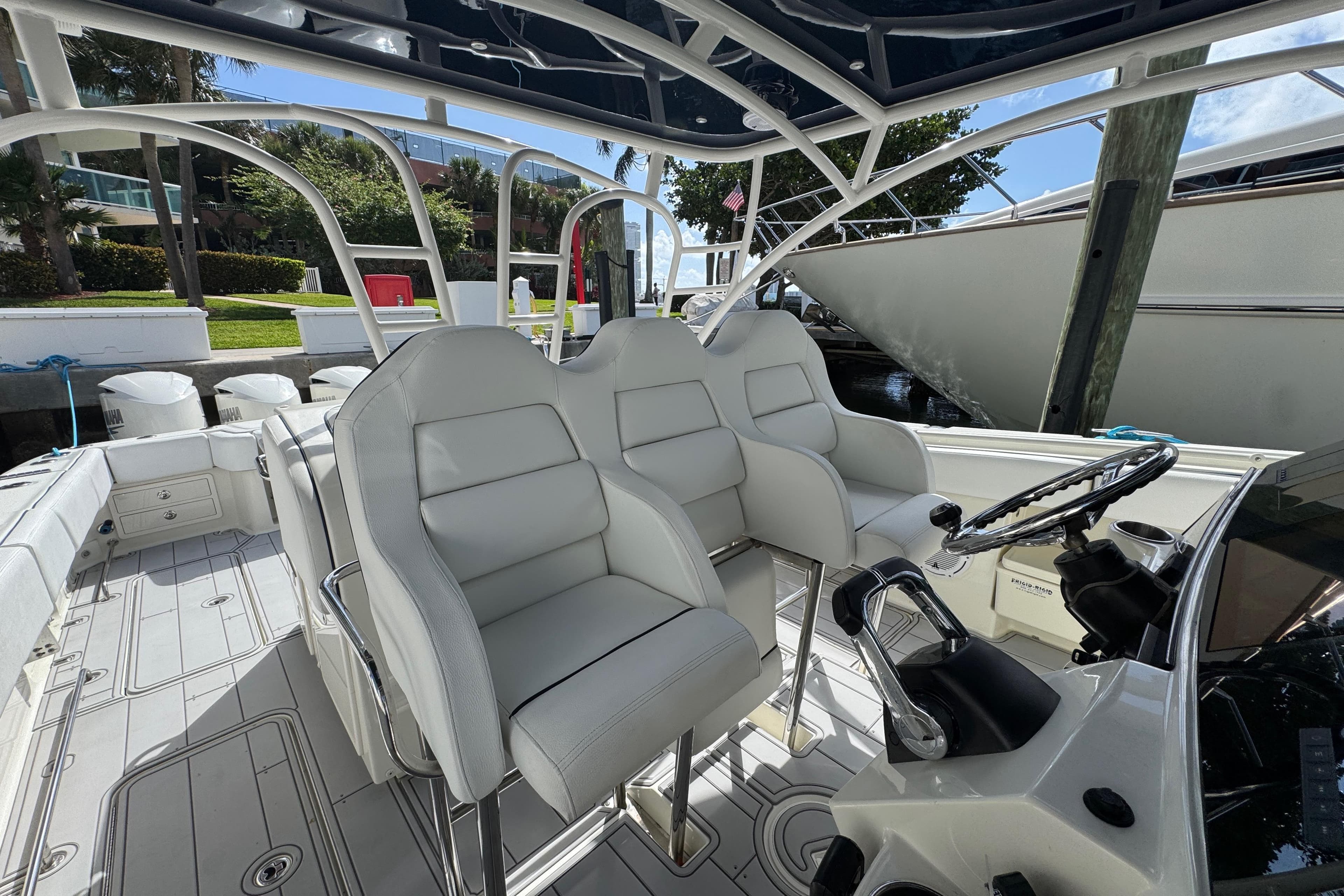 Interior view of a 2012 Hydra-Sports 4200 SF boat with white seating and steering wheel.
