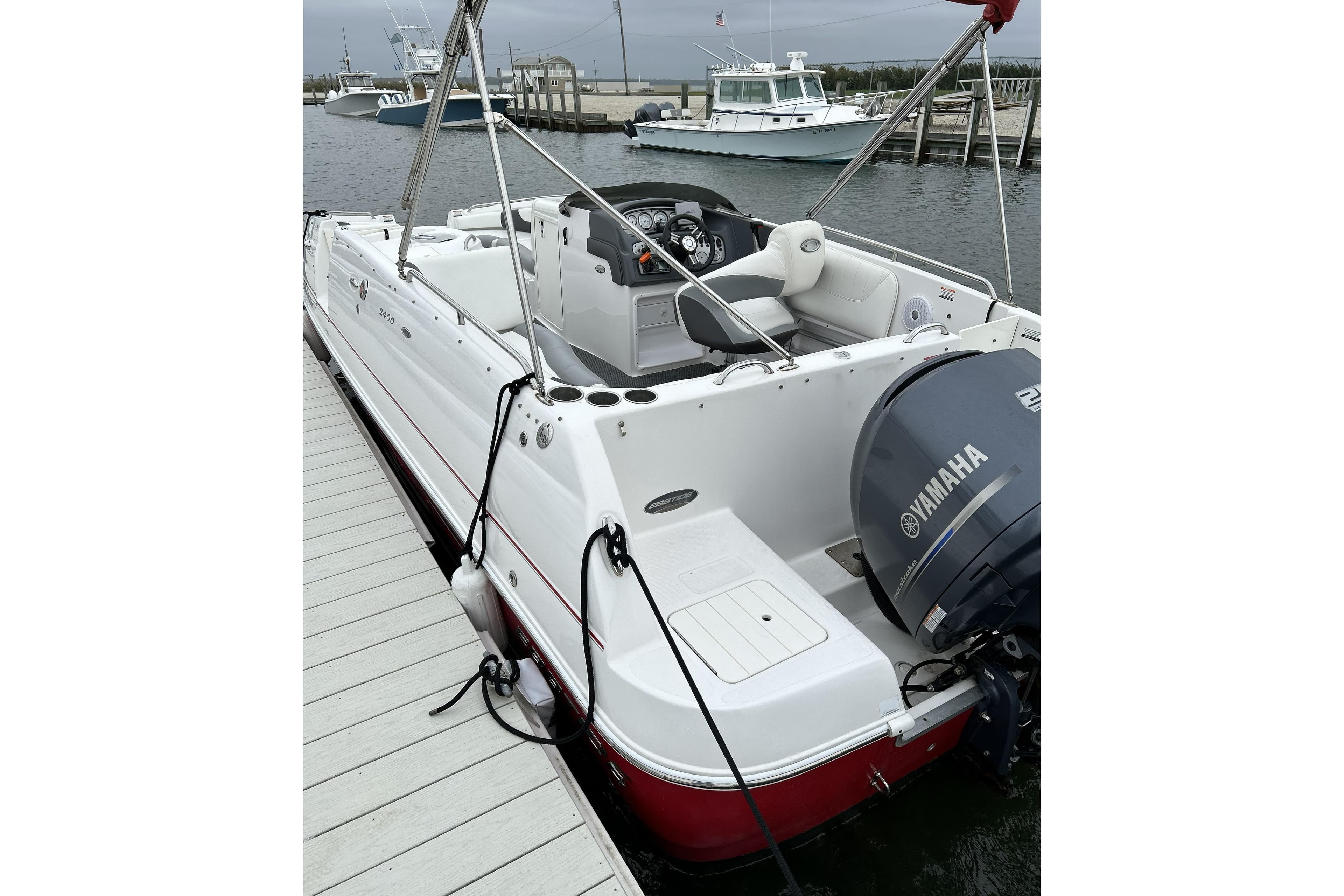 2014 Ebbtide 2400 SS Fun Cruiser DC Sport boat docked with Yamaha engine.